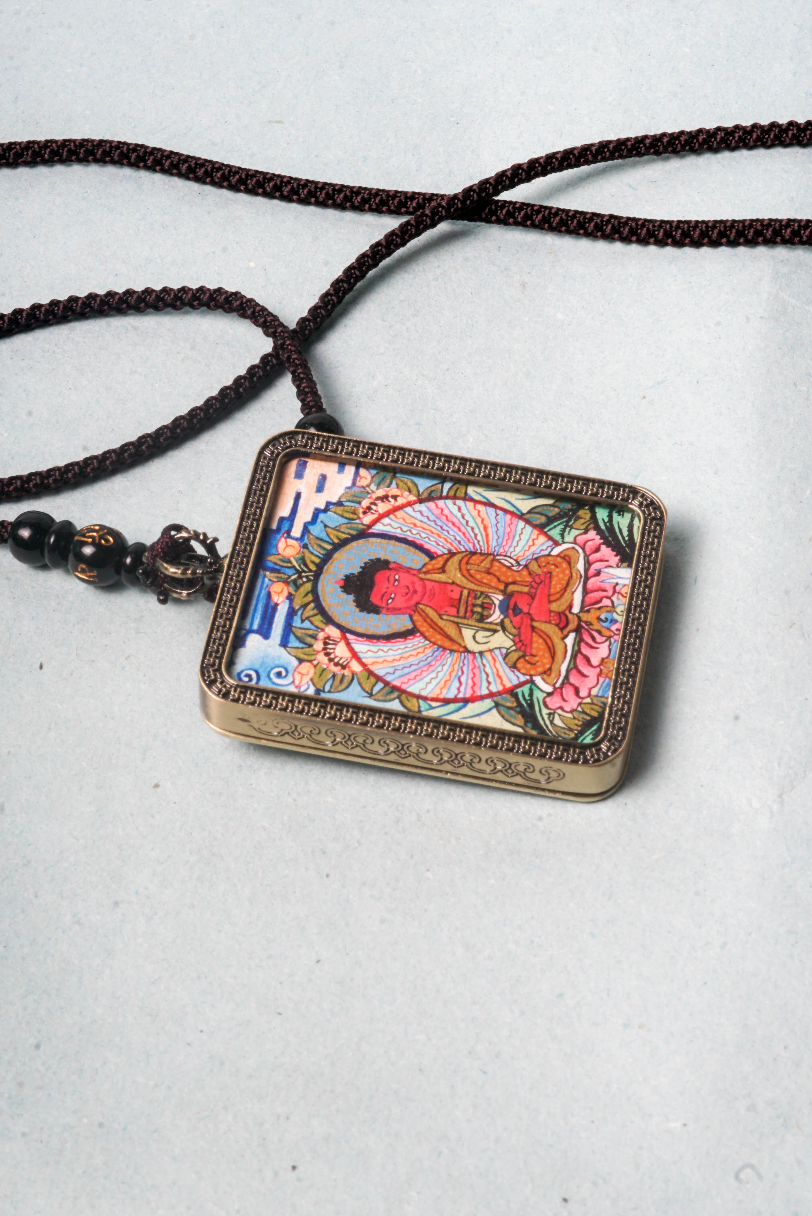 The genuine Amitabha Ghau Thangka, hand-painted with natural mineral pigments, beautifully captures Amitabha Buddha’s serene and compassionate presence.
