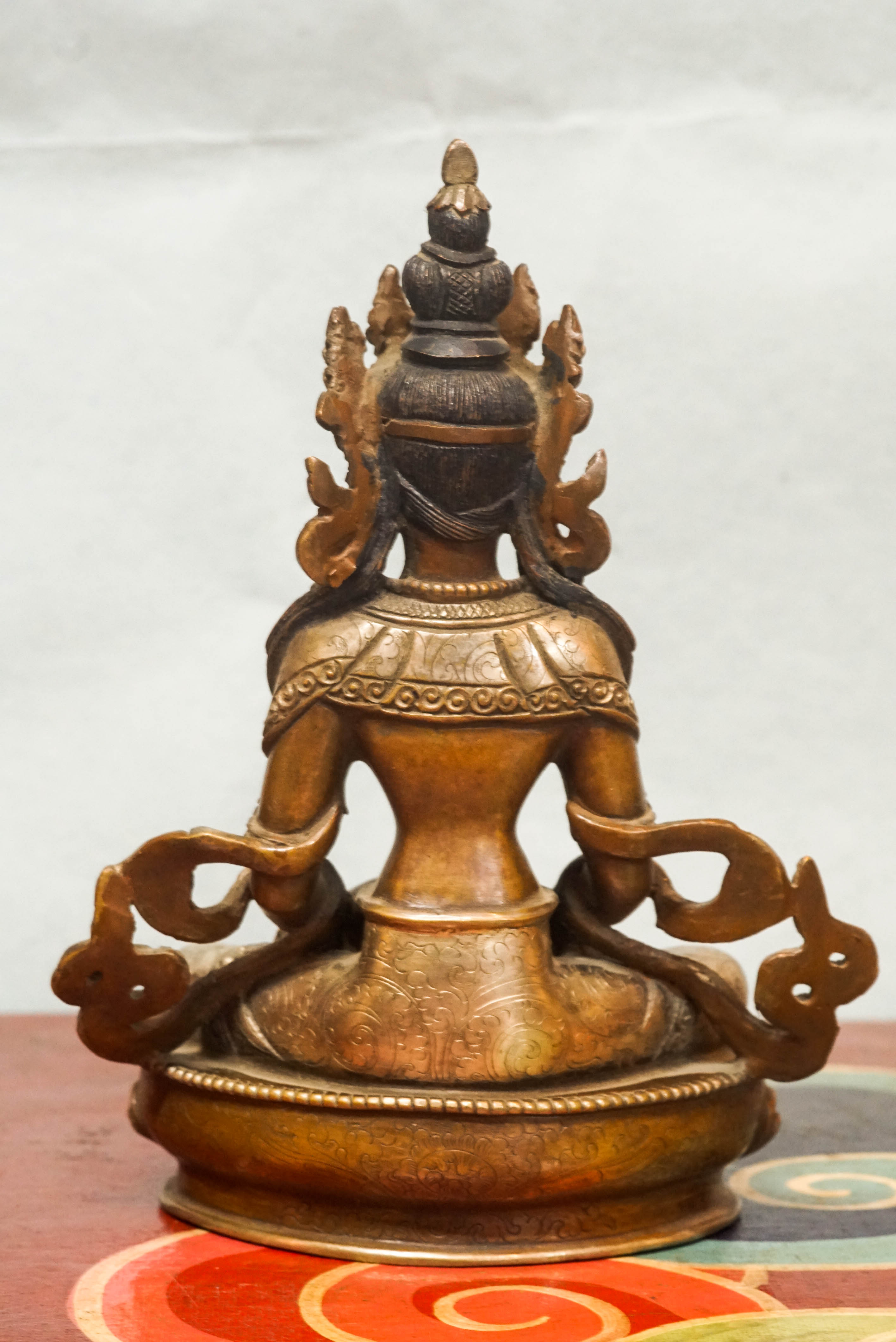 Seated Amitayus statue in lotus posture, symbolizing longevity, vitality, and spiritual wisdom.