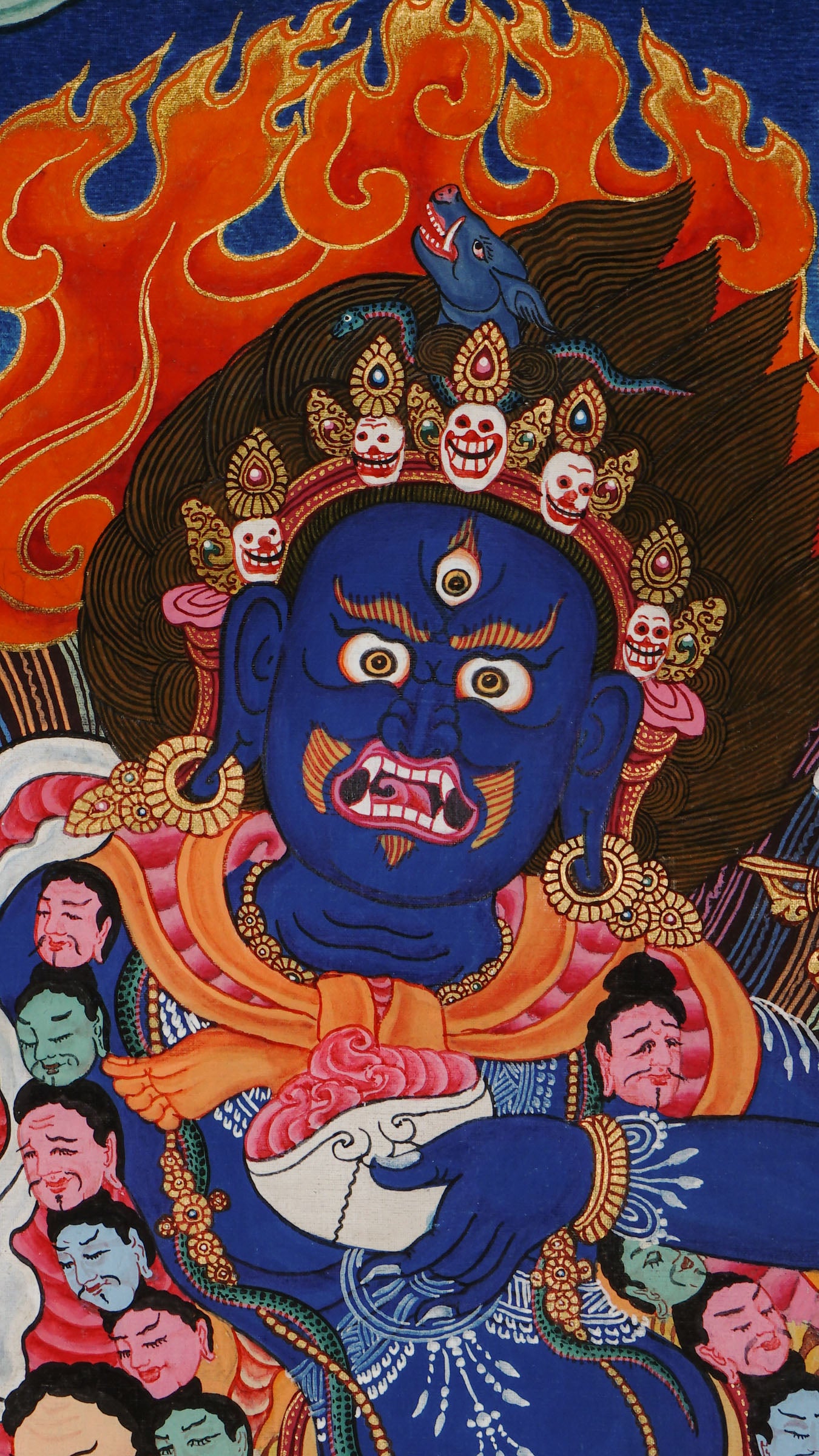 Wrathful wisdom dakini with boar’s head, holding vajra and skull cup, dancing in flames on a subdued figure, hand-painted with natural pigments and gold on cotton canvas in Nepal.