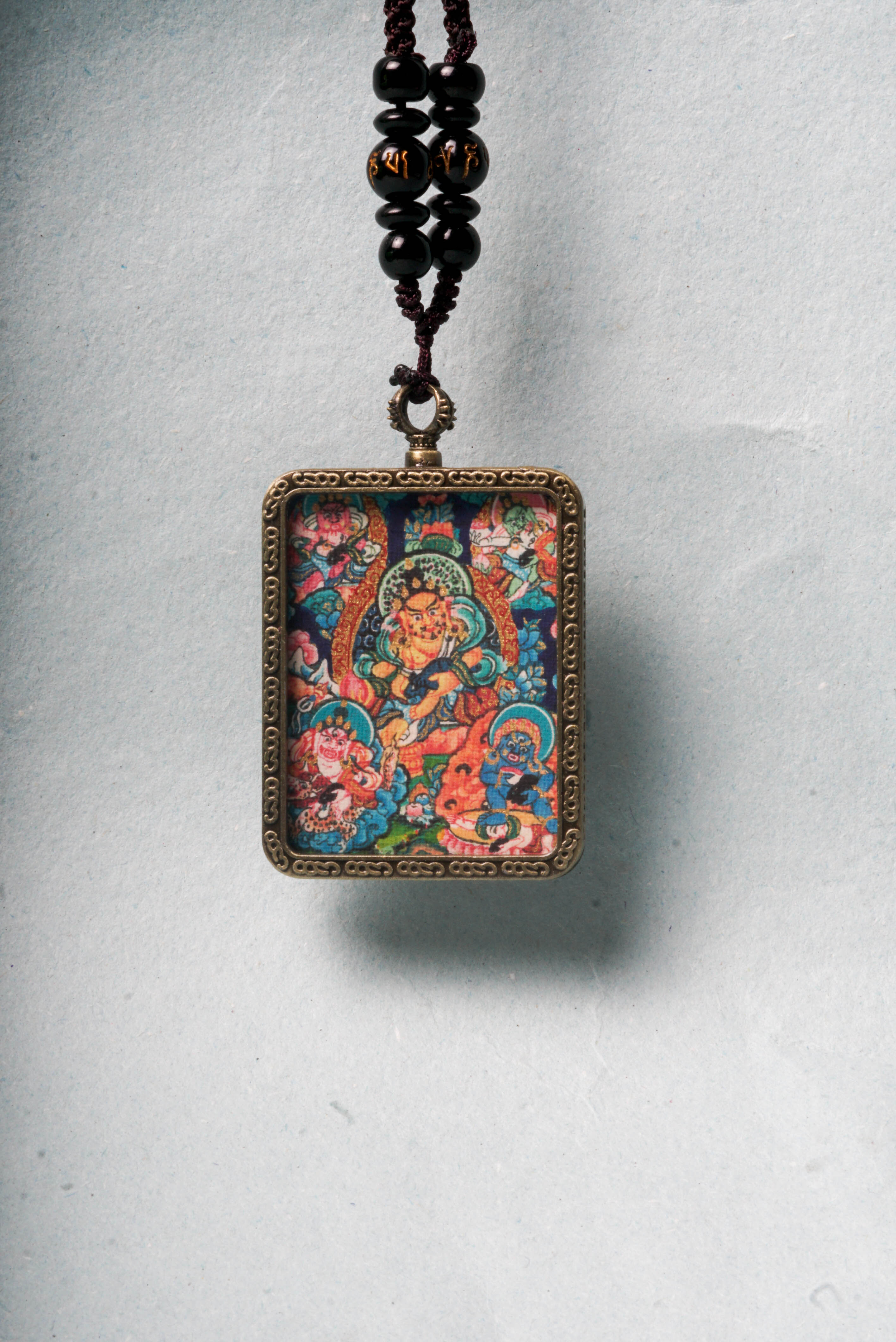 The genuine Five Zambala Ghau Thangka features all five Tibetan Buddhist wealth deities, symbolizing prosperity, generosity, and the removal of obstacles. Hand-painted with natural mineral pigments, this portable shrine is both a powerful talisman and sacred artwork for attracting abundance and spiritual growth.