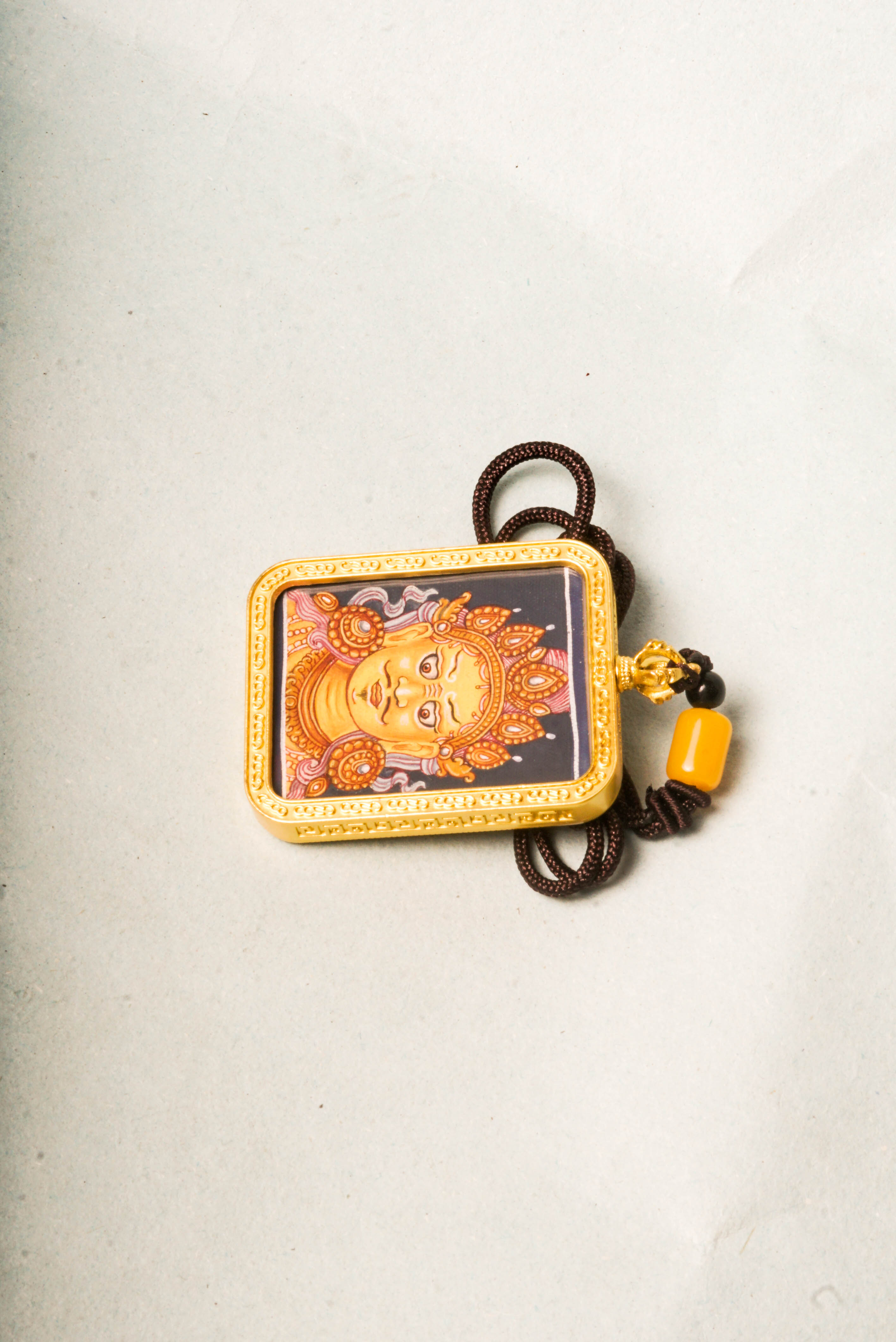 This Newari Zambala Ghau Thangka depicts the Tibetan Buddhist god of wealth holding a jewel-spouting mongoose, symbolizing prosperity and protection. Handcrafted in vibrant Newari style, it's ideal for personal altars or as a spiritual amulet.