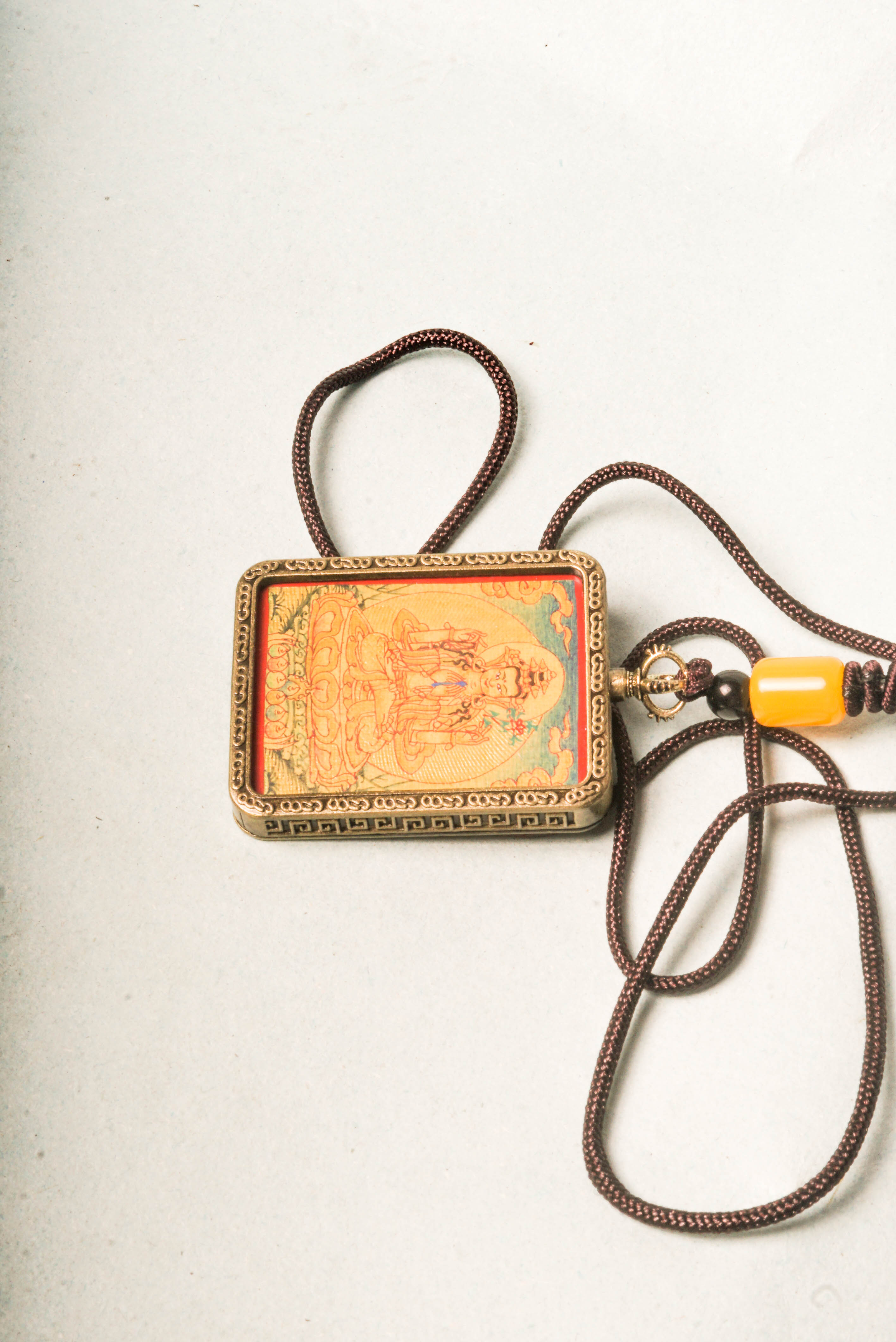 Chenrezig, the Bodhisattva of compassion, is depicted in this stunning gold Lyap Ghau Thangka, handcrafted by skilled artisans using natural mineral pigments. Perfect as a personal amulet or sacred display, it inspires meditation, protection, and spiritual growth.