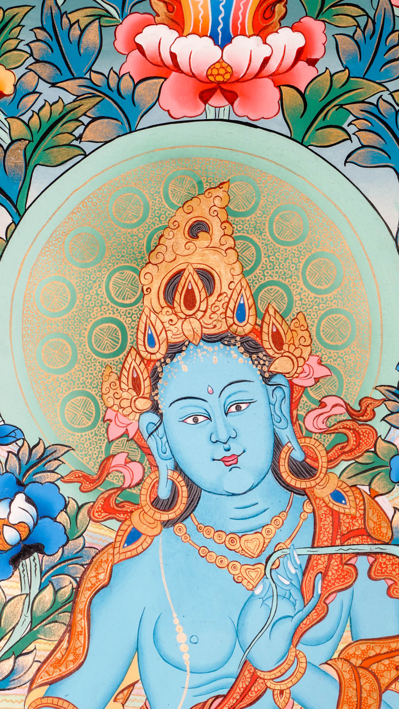 Tibetan thangka of Green Tara in a blue-green form seated in lalitasana on a golden lotus throne, holding a lotus and showing the varada mudra, surrounded by flowers and a peaceful background.