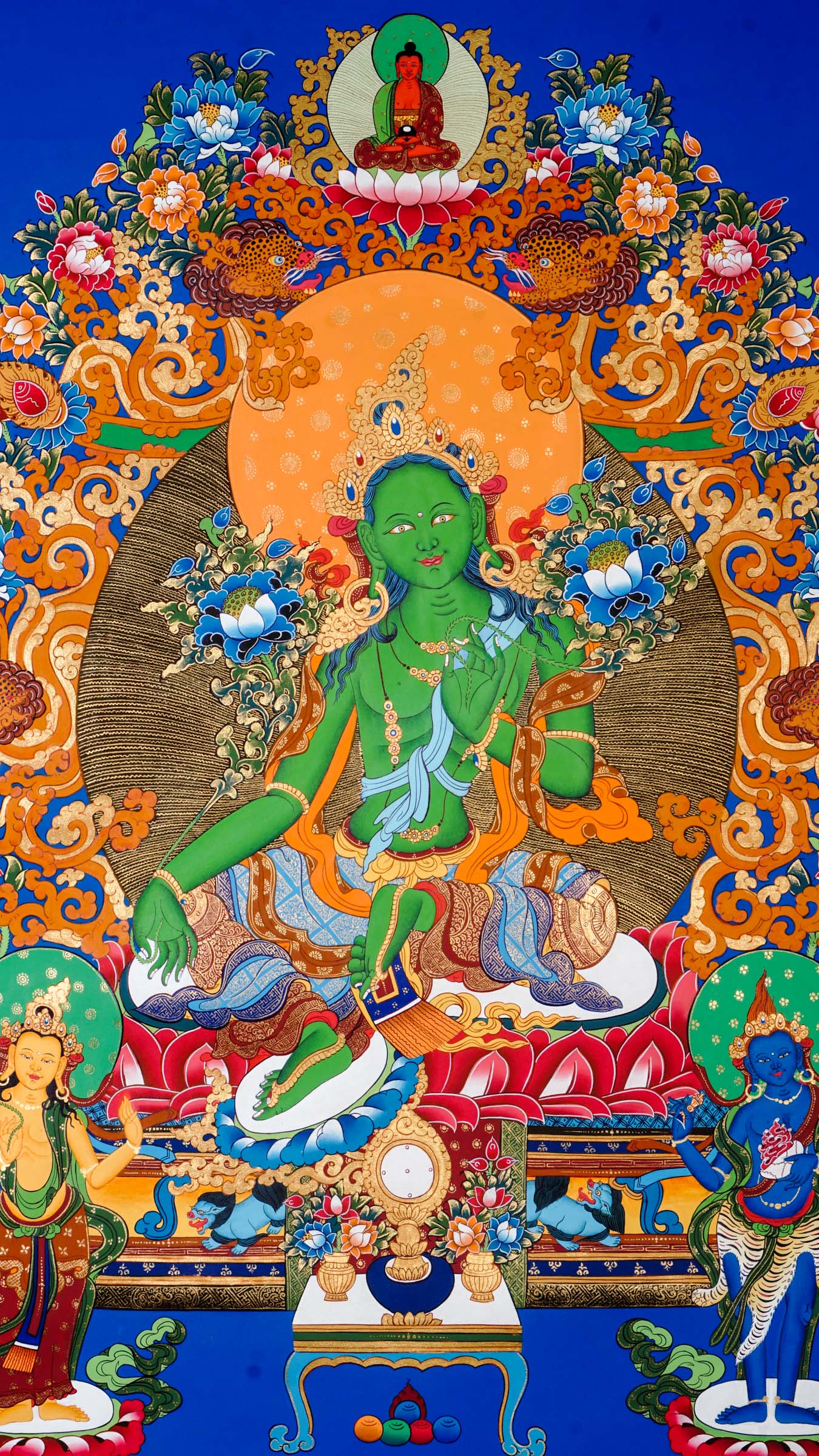 Tibetan thangka of Green Tara in green form seated in lalitasana on a golden lotus throne, right hand in varada mudra, left hand holding a blue lotus, surrounded by flowers and divine light.