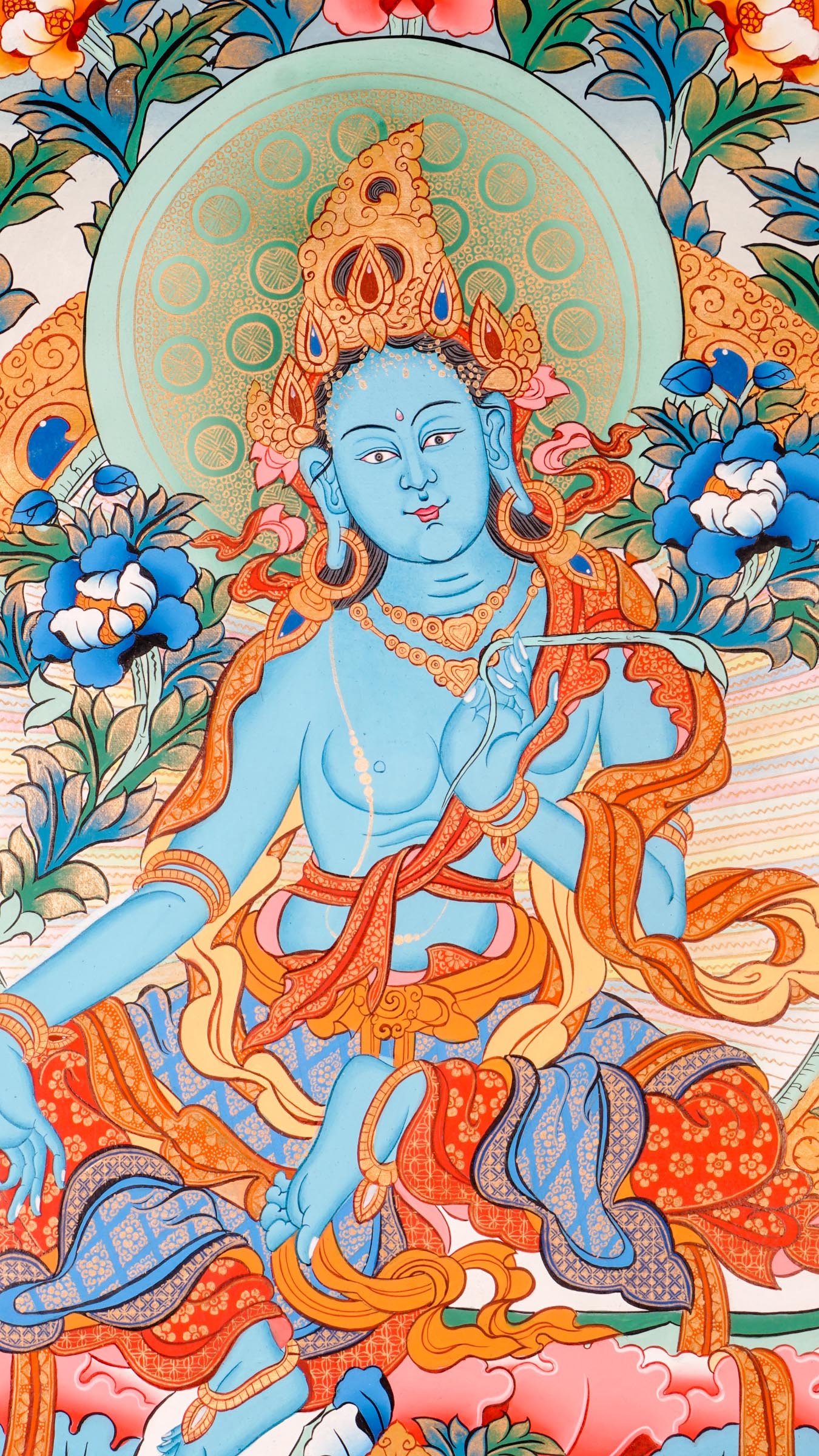 Tibetan thangka of Green Tara in a blue-green form seated in lalitasana on a golden lotus throne, holding a lotus and showing the varada mudra, surrounded by flowers and a peaceful background.
