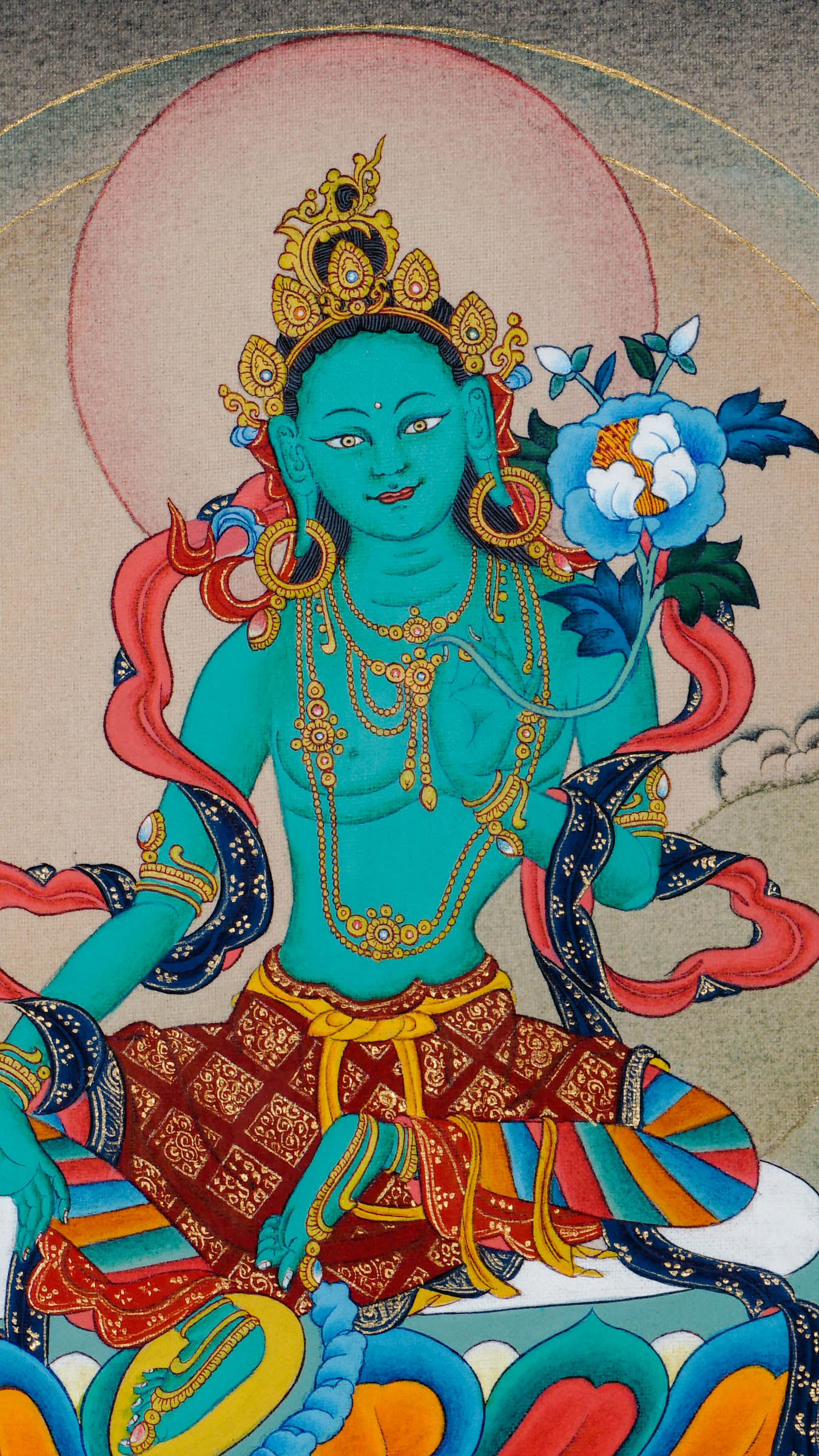 Tibetan thangka of Green Tara seated in lalitasana on a lotus throne, right hand in varada mudra and left hand holding a blue lotus, surrounded by a serene and peaceful background.