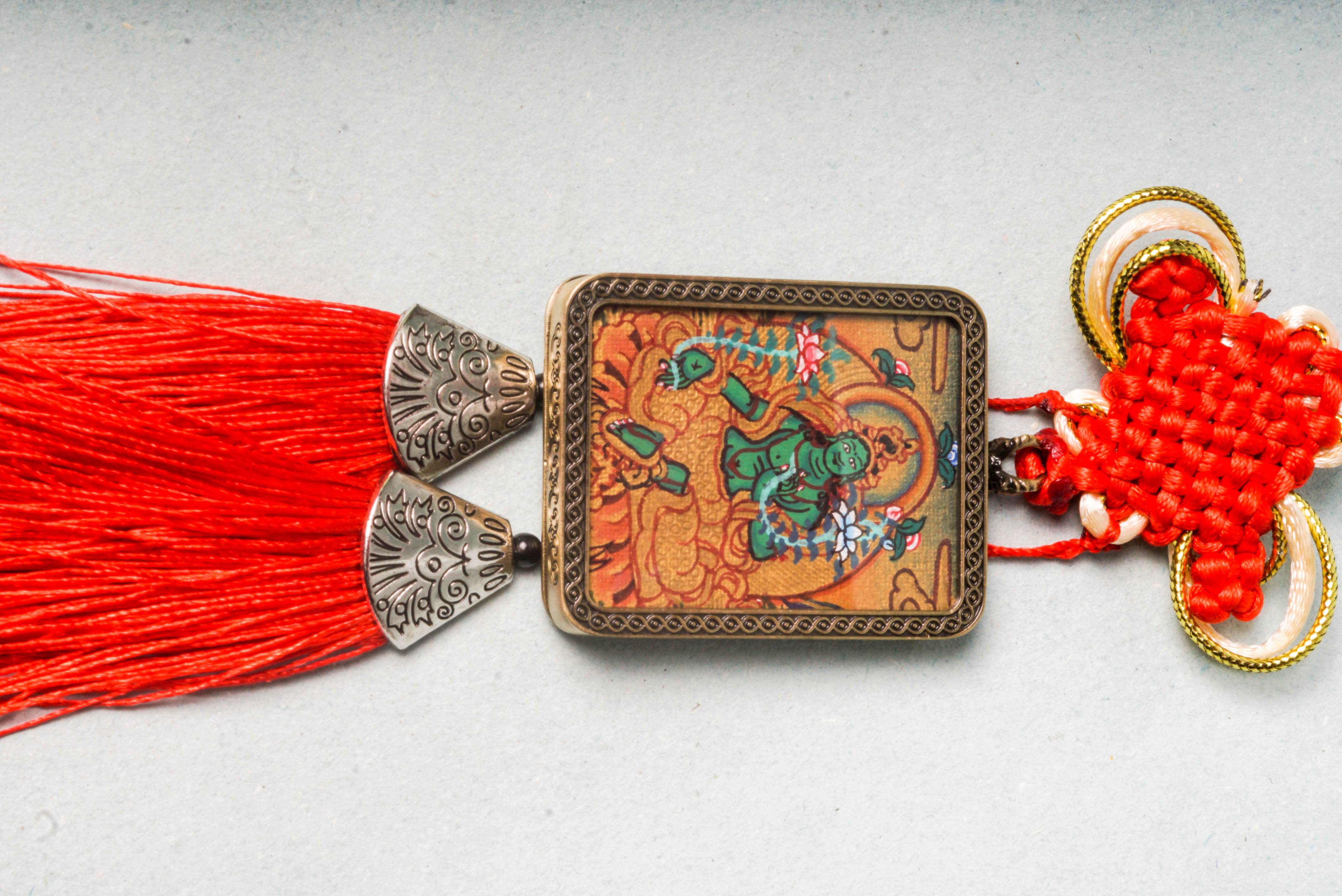 The Green Tara Ghau Thangka is a hand-painted sacred artwork symbolizing compassion, protection, and swift healing. Featuring her vibrant green form and crafted with natural pigments, it serves as a portable shrine to invite Tara’s blessings and grace into your space.