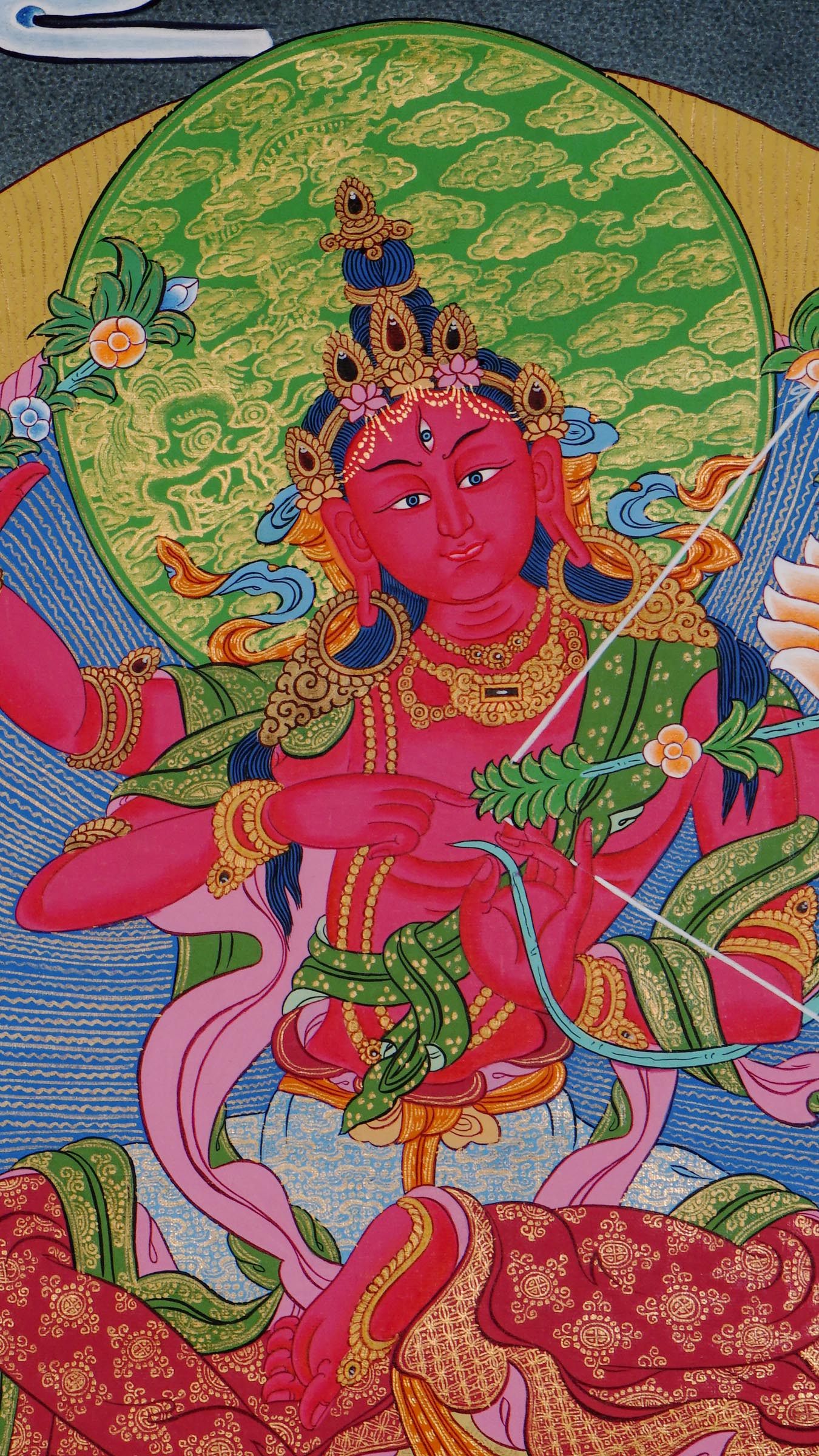 Hand-painted Kurukulla thangka from Kathmandu, Nepal depicting the red semi-wrathful goddess of magnetizing power with four arms holding a flower bow, flower arrow, flower hook and flower noose, dancing on a prone figure and wearing a garland of severed heads in traditional Tibetan Vajrayana style.