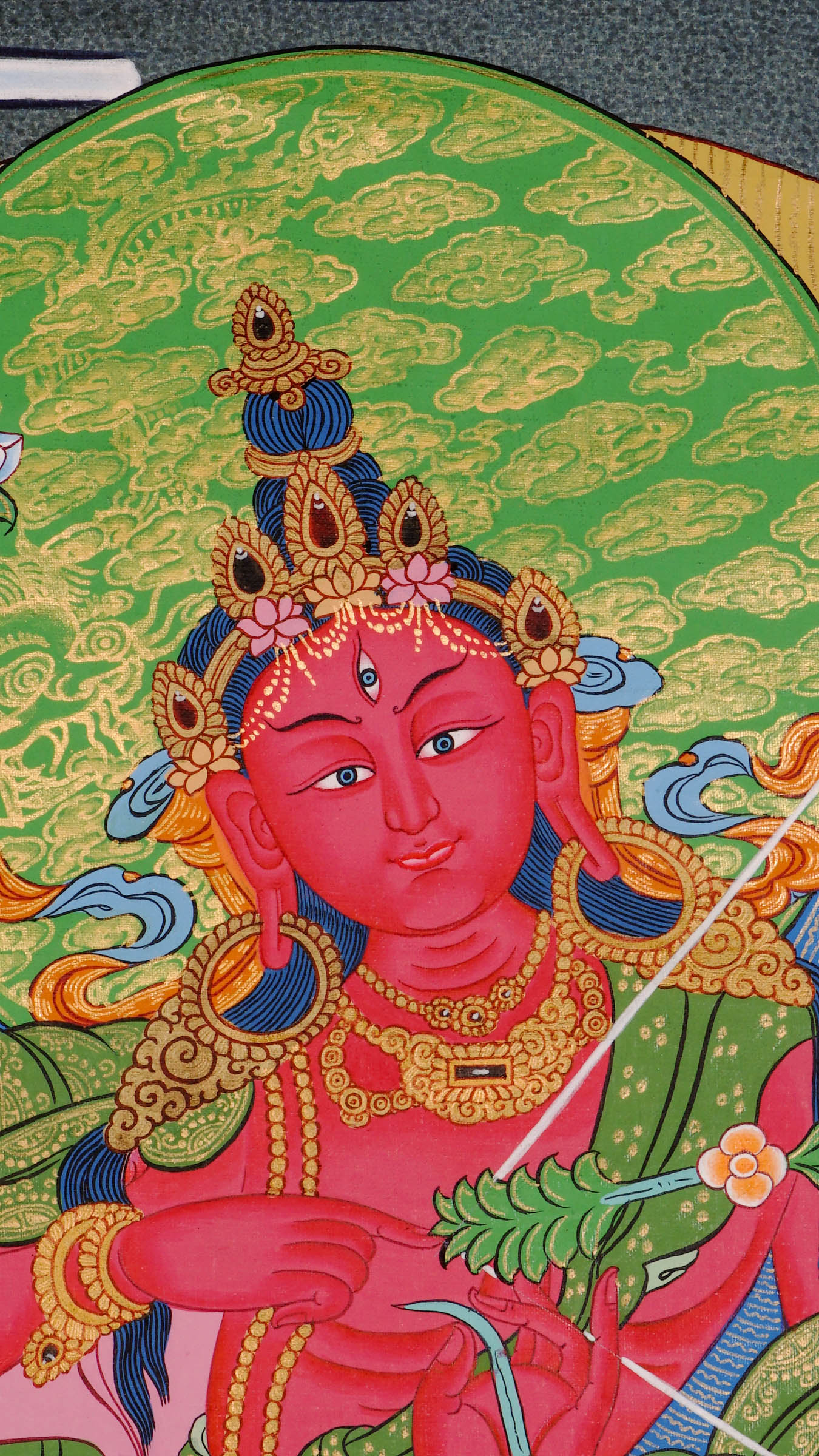 Hand-painted Kurukulla thangka from Kathmandu, Nepal depicting the red semi-wrathful goddess of magnetizing power with four arms holding a flower bow, flower arrow, flower hook and flower noose, dancing on a prone figure and wearing a garland of severed heads in traditional Tibetan Vajrayana style.