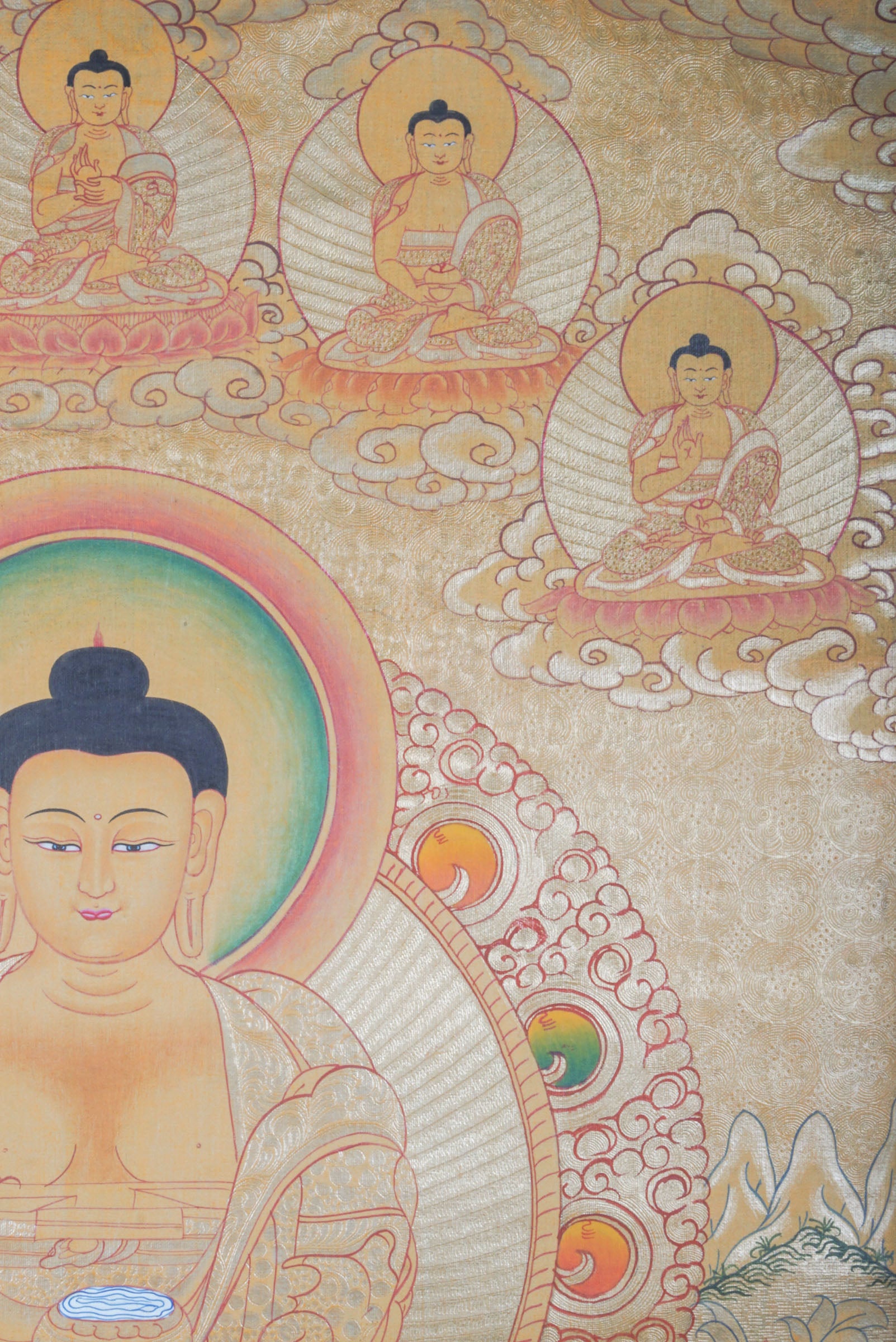 Amitabha Buddha on Gold- a depiction of a seated Buddha figure with decorative elements on a textured background