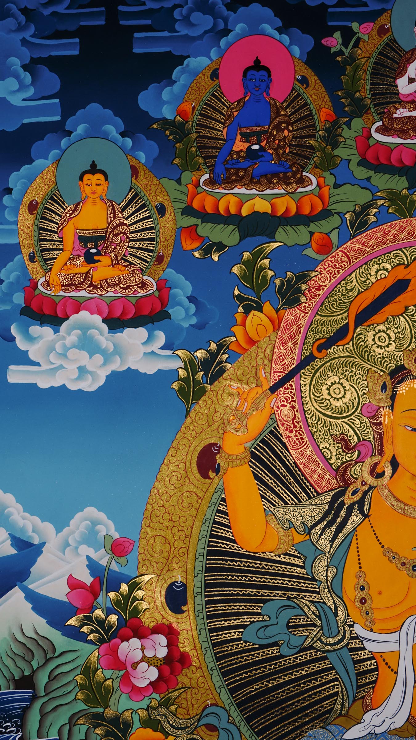 Hand painted Manjushri thangka from Kathmandu, Nepal, depicting the Bodhisattva of wisdom seated on a lotus throne holding a flaming sword and sutra on lotus, with Chenrezig, Mahakala, and Five Dhyani Buddhas, in traditional Tibetan Vajrayana style with 24k gold.