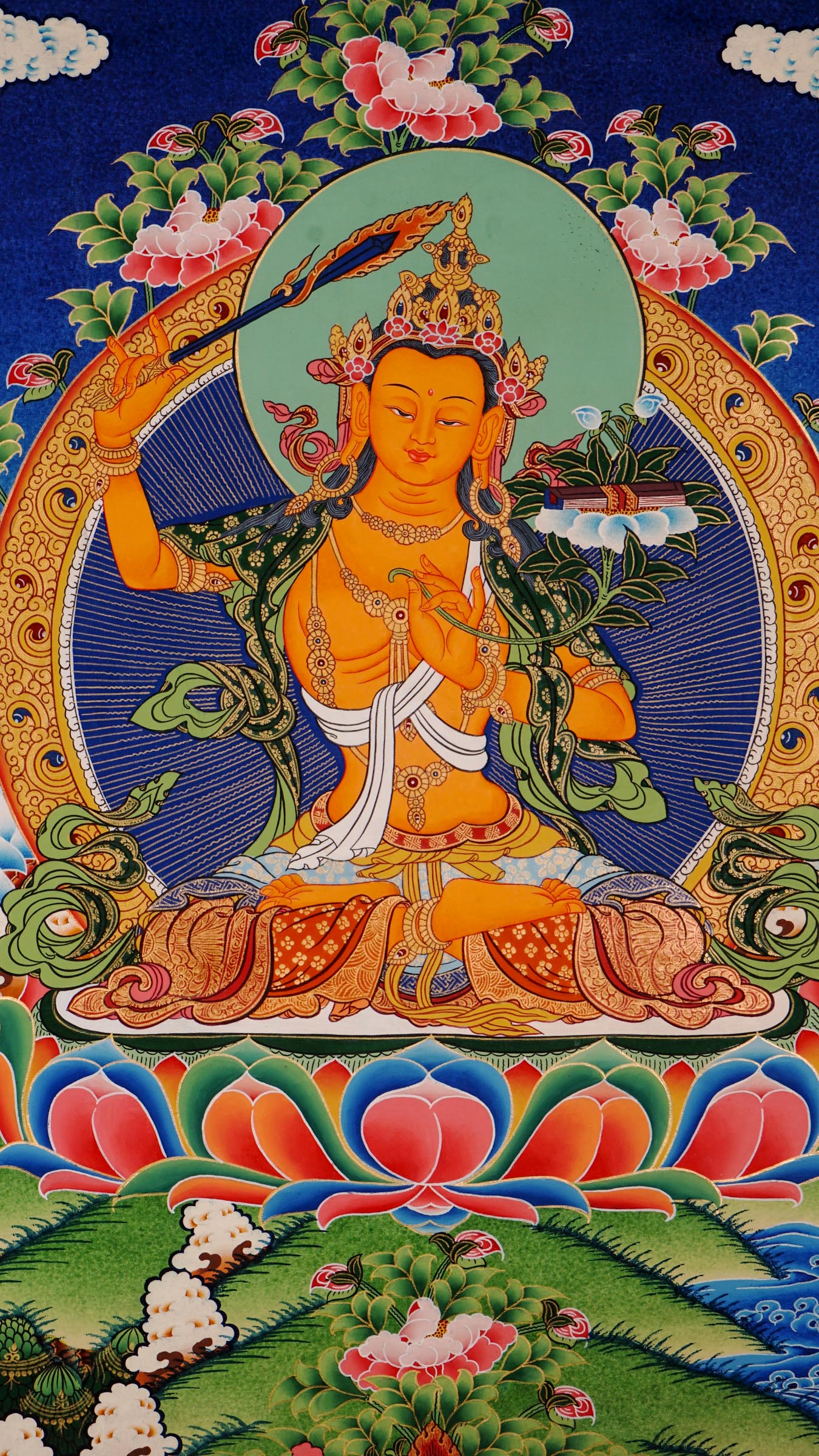 Traditional Manjushree Thangka from Nepal, hand-painted with 24K gold, showing the Bodhisattva of Wisdom seated on a lotus throne with floral motifs in the background.