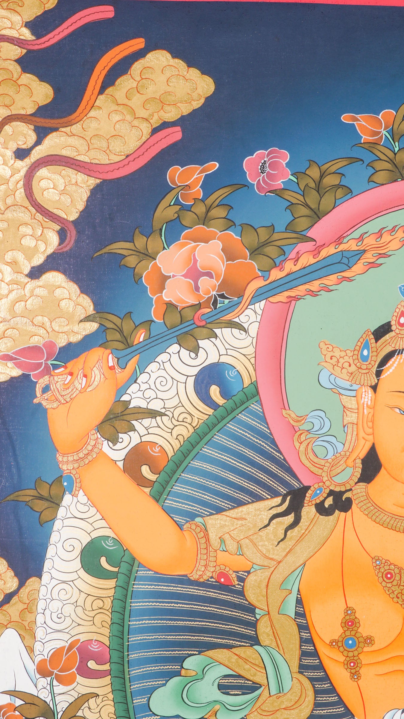The Manjushree Thangka depicting the Bodhisattva of Wisdom seated on a lotus, holding a sword and a scripture.