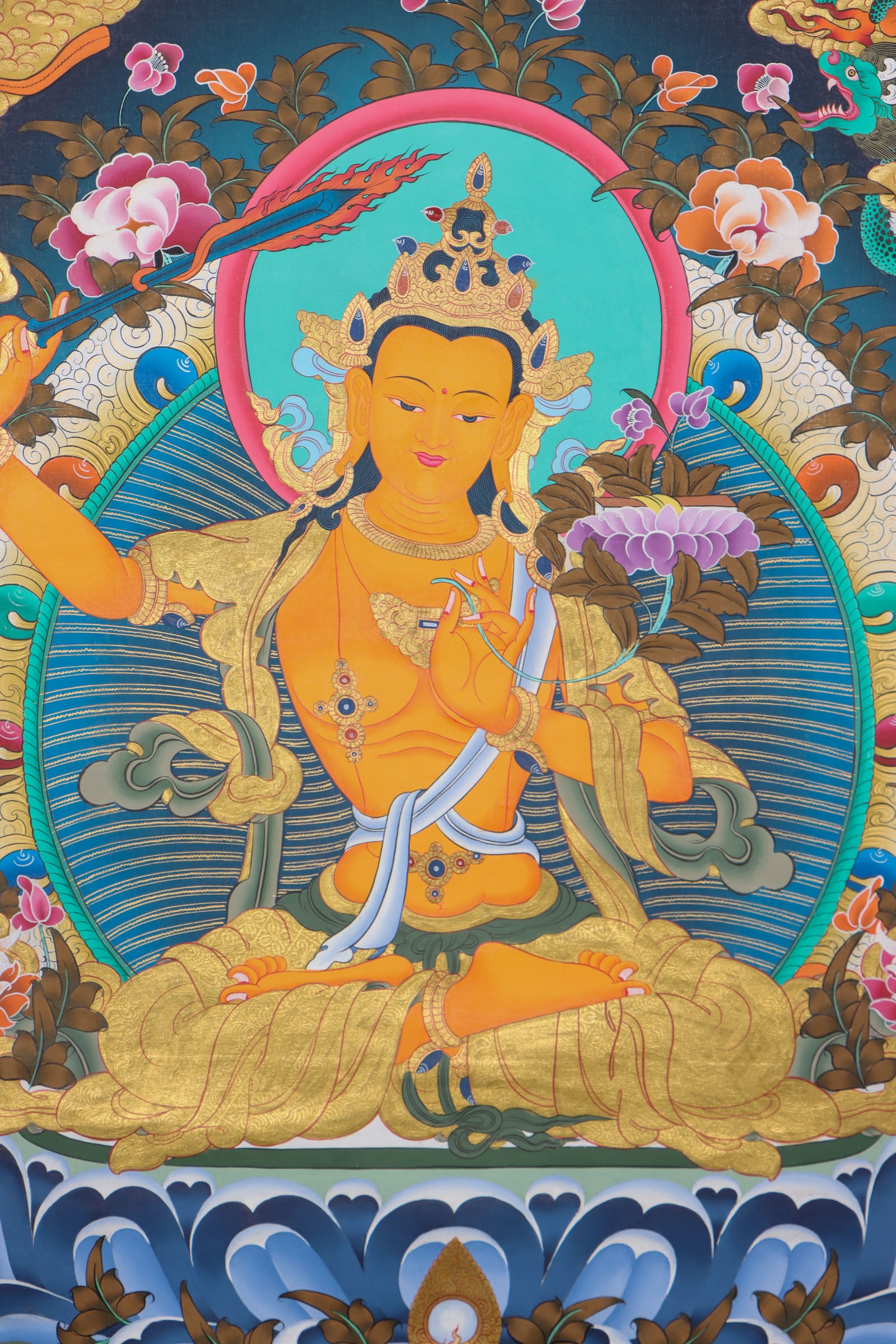 This genuine Manjushri Thangka captures the Bodhisattva of wisdom holding his iconic sword and scripture, symbolizing the power to cut through ignorance and reveal ultimate truth. Hand-painted with natural mineral pigments on canvas, it is a powerful spiritual tool for those seeking clarity, insight, and enlightenment.
