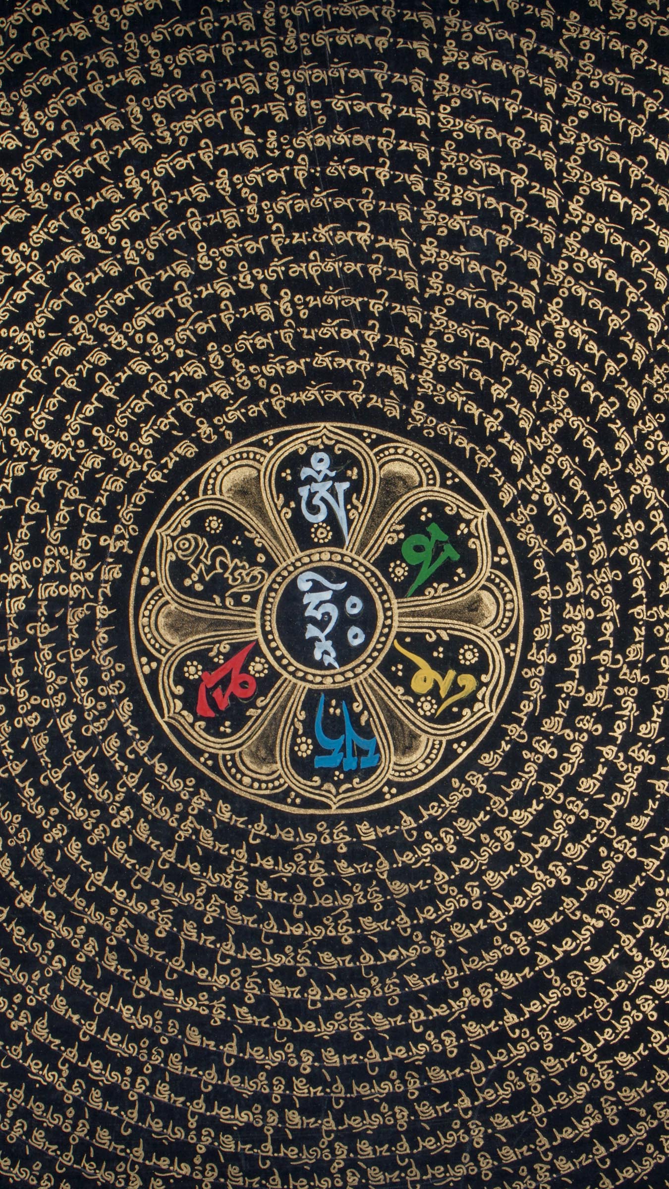 A detailed hand-painted artwork featuring a mandala design with intricate patterns and mantra at the center predominantly in gold and black colors.