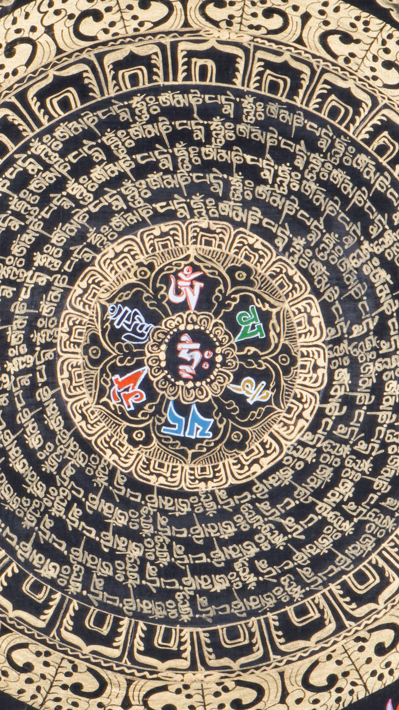 Tibetan mantra mandala thangka with concentric rings of Om Mani Padme Hum script, surrounded by four dragon guardians, ornate gold detailing, and jewel symbols on a black background.