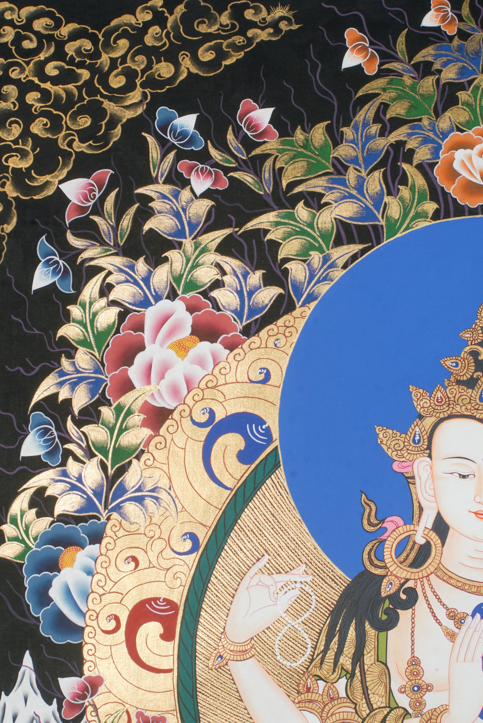 Hand-painted Thangka art portraying Chengresi, Avalokiteshvara in her serene form seated in a Lotus throne, created with 24k gold and natural pigments.