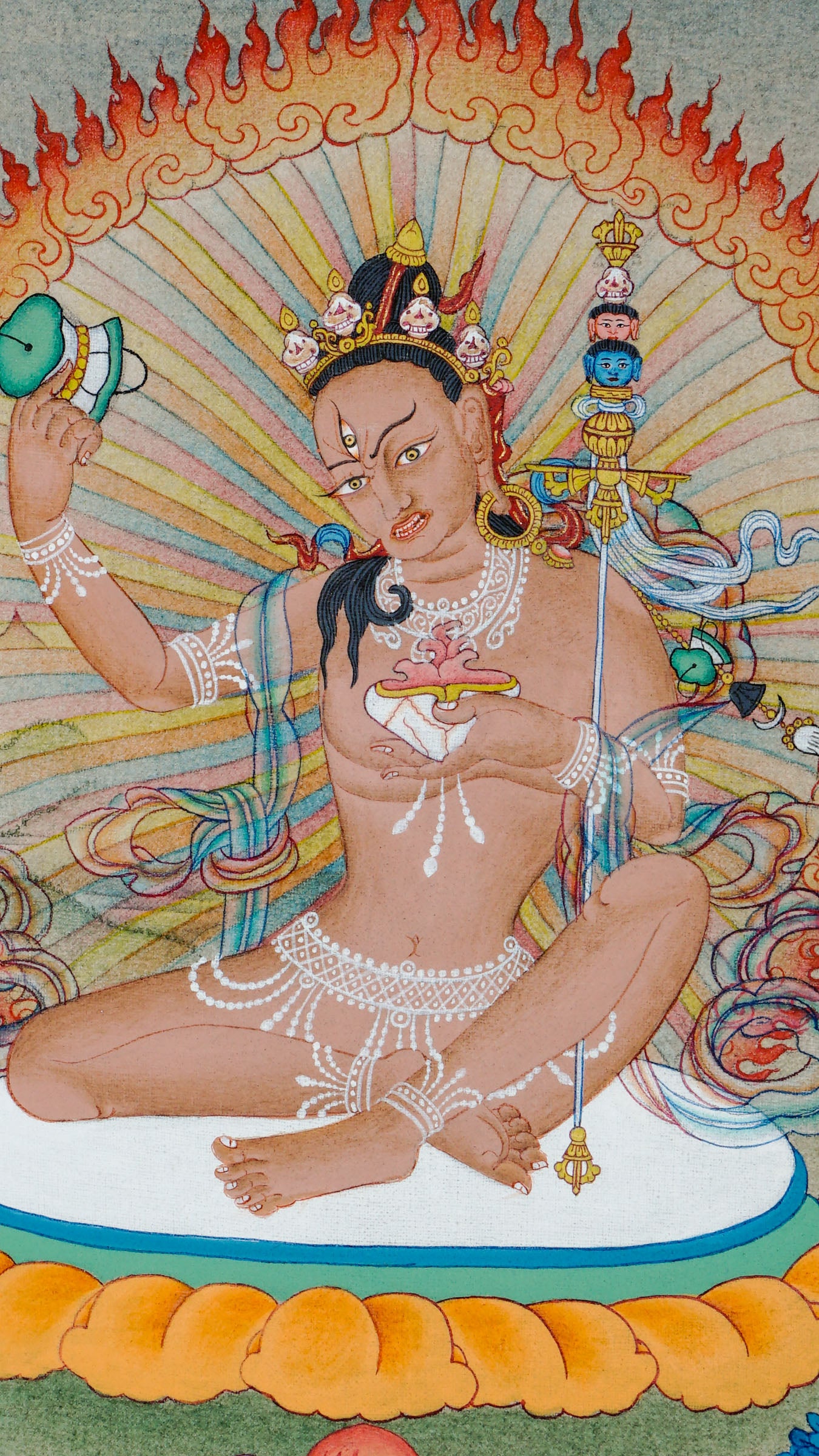 Hand painted thangka of Jetsun Niguma seated on a lotus cushion, surrounded by flames of wisdom, holding a skull cup and staff, adorned with bone ornaments and jewelry, set against a peaceful landscape background.