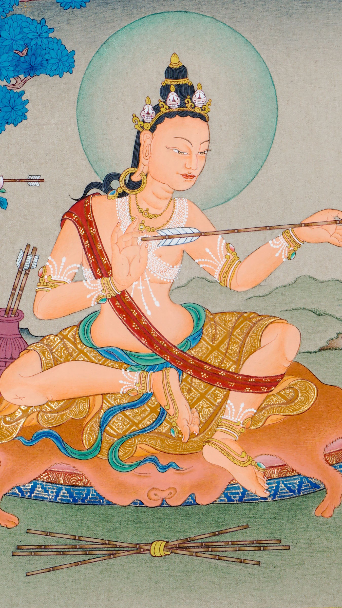 Hand painted thangka of Mahasiddha Saraha seated on a deer skin mat, holding an arrow symbolizing insight, with a quiver beside him and a serene blue tree and landscape in the background.