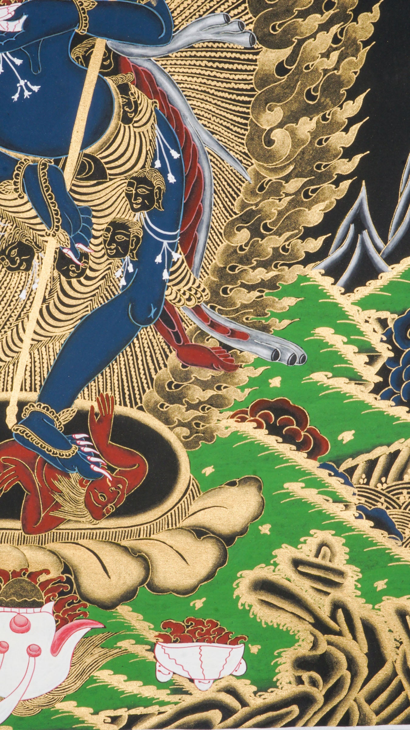 Traditional Tibetan thangka painting depicting Singh Mukhi, the lion-faced protector dakini, shown in a dynamic dancing pose on a lotus base, surrounded by radiant gold flames and intricate symbolic patterns on a dark background.