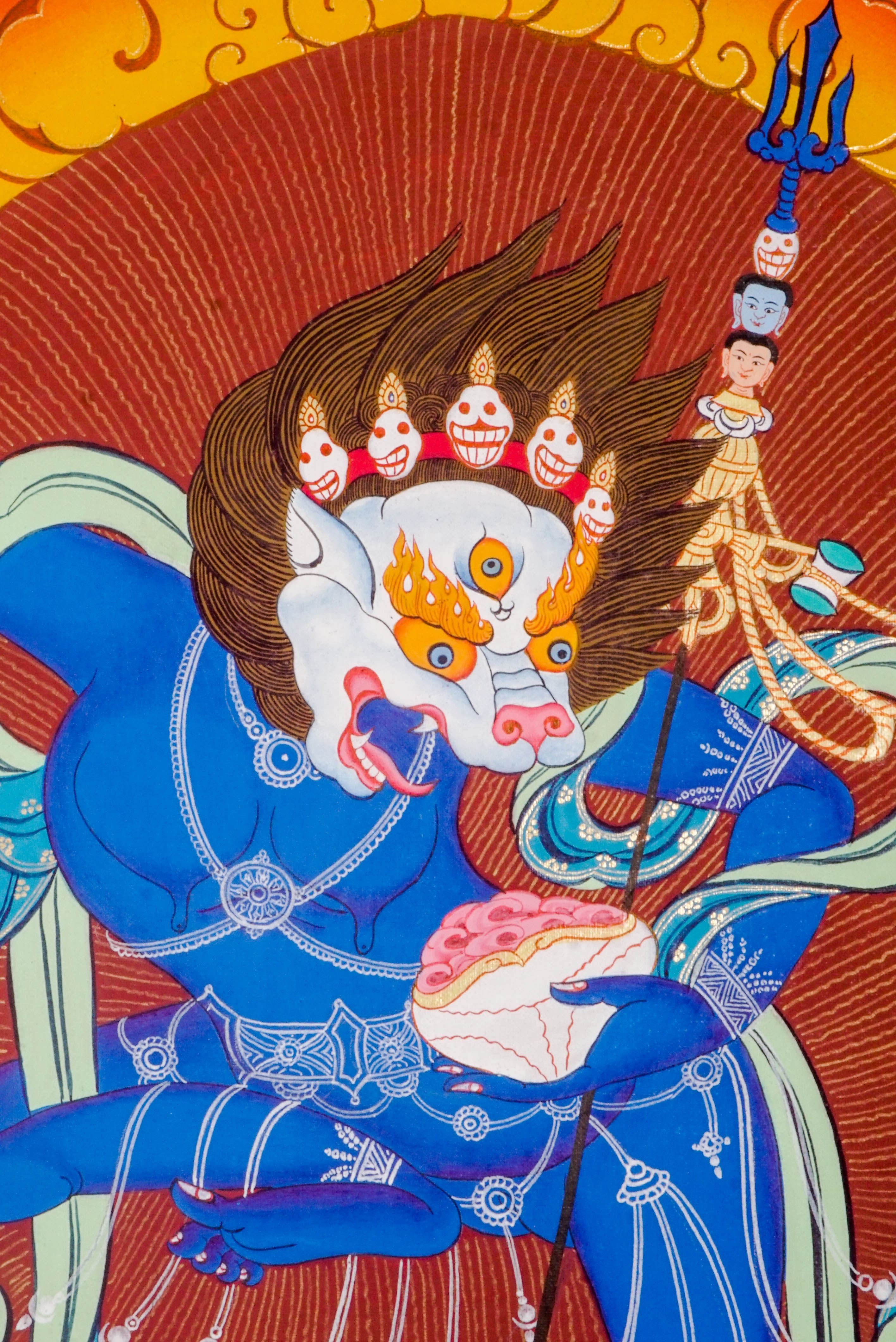 The Simhamukha Thangka shows the fierce Lion-Faced Dakini, a Tibetan Buddhist protector who removes negativity and ignorance. Hand-painted with natural pigments, it brings strength, clarity, and divine protection to any sacred space.