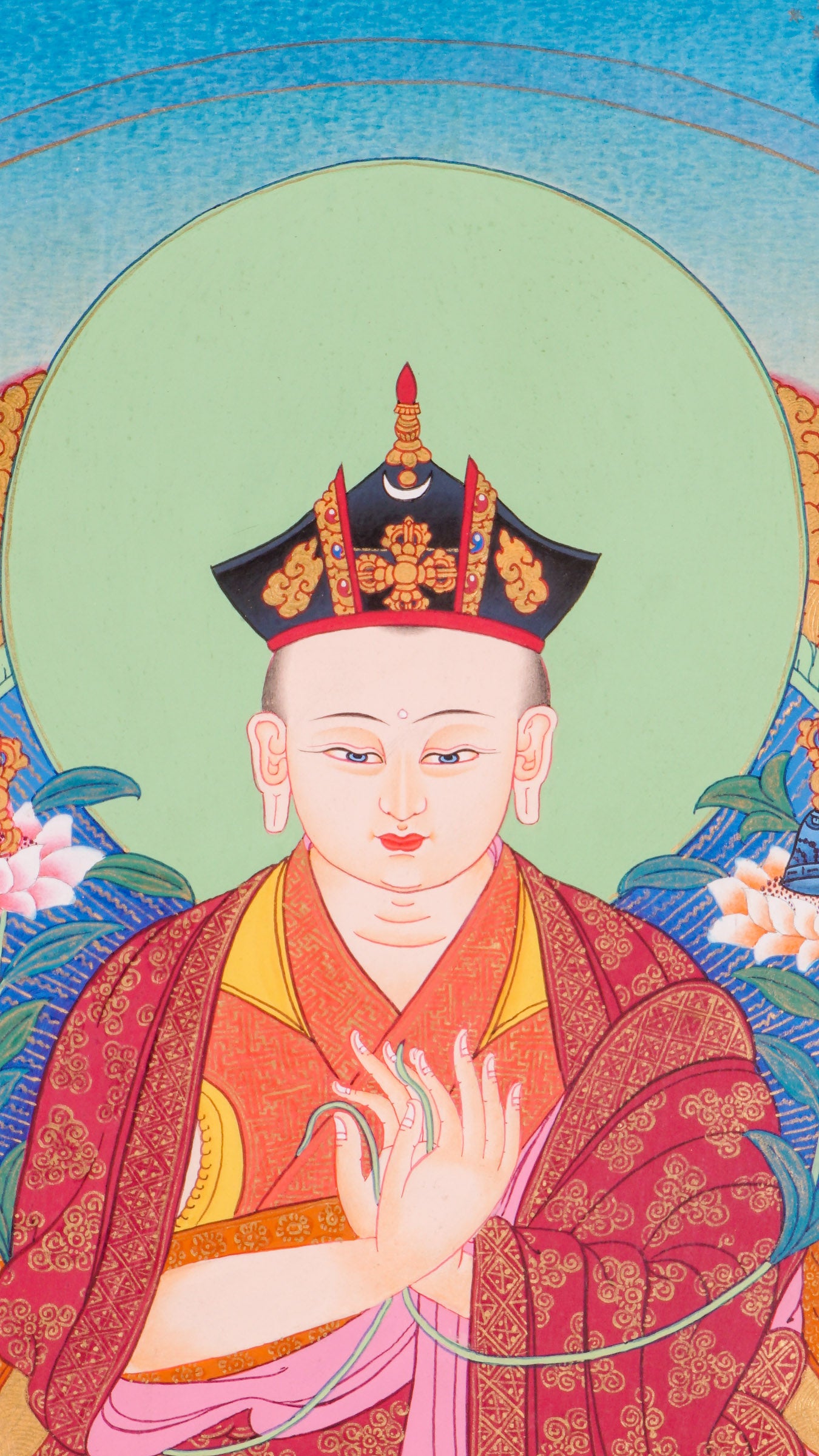 Traditional Tibetan thangka painting depicting the Karmapa Lama seated in meditation on a lotus throne, shown with a serene expression, monastic robes, a radiant halo, and surrounded by clouds, flowers, and a peaceful landscape.