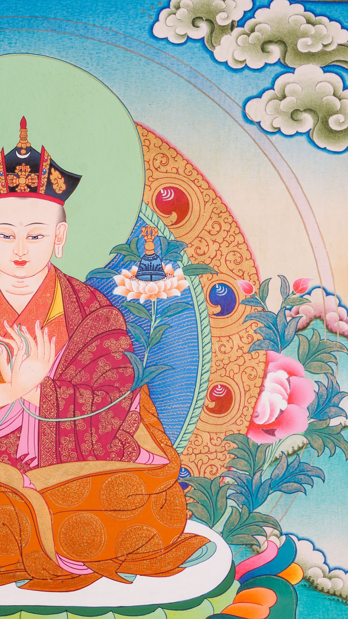 Traditional Tibetan thangka painting depicting the Karmapa Lama seated in meditation on a lotus throne, shown with a serene expression, monastic robes, a radiant halo, and surrounded by clouds, flowers, and a peaceful landscape.