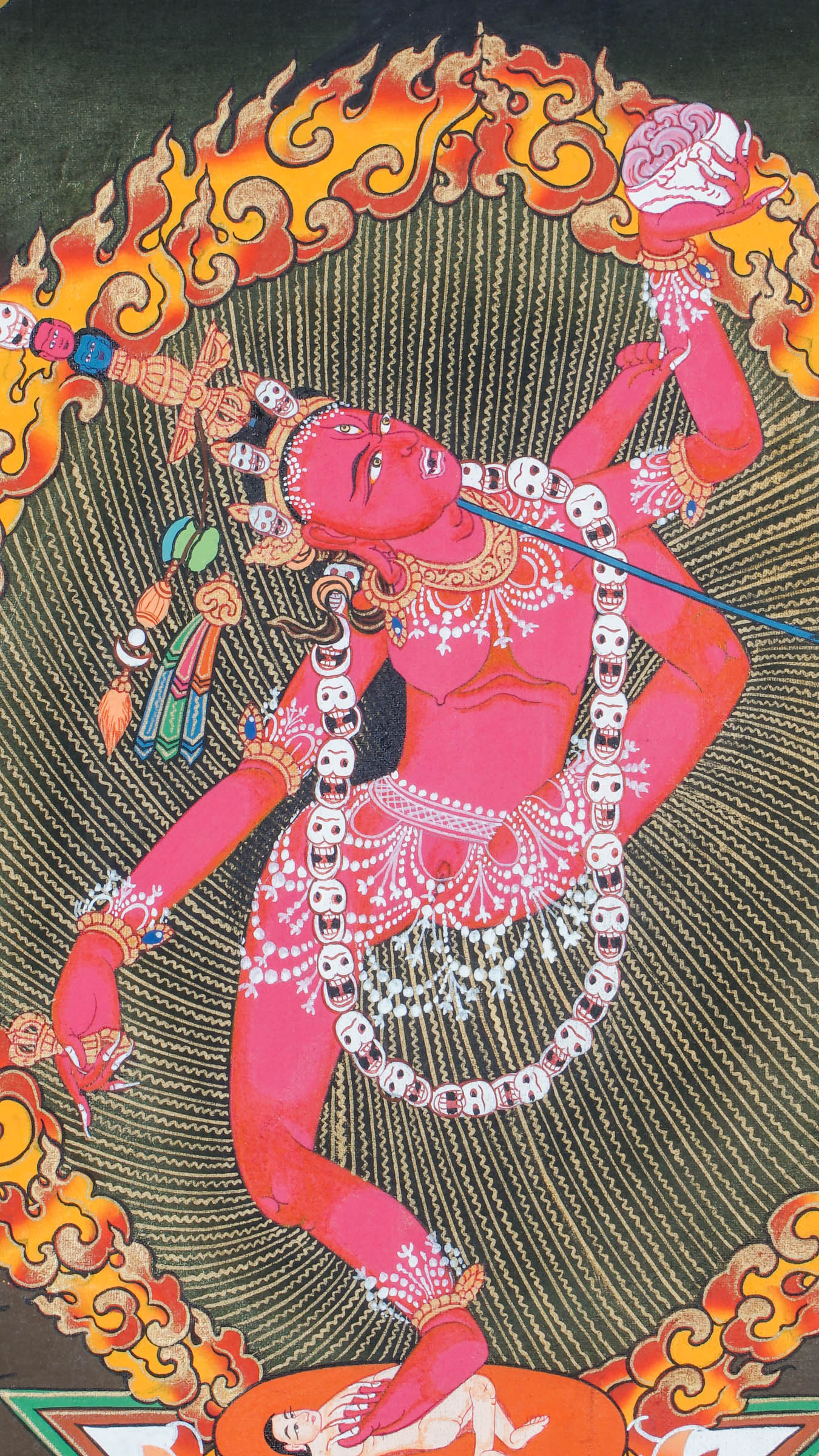 Traditional Tibetan thangka painting depicting Vajrayogini in a dynamic dancing pose on a lotus throne, encircled by flames and clouds, holding ritual implements against a warm, mountainous landscape.