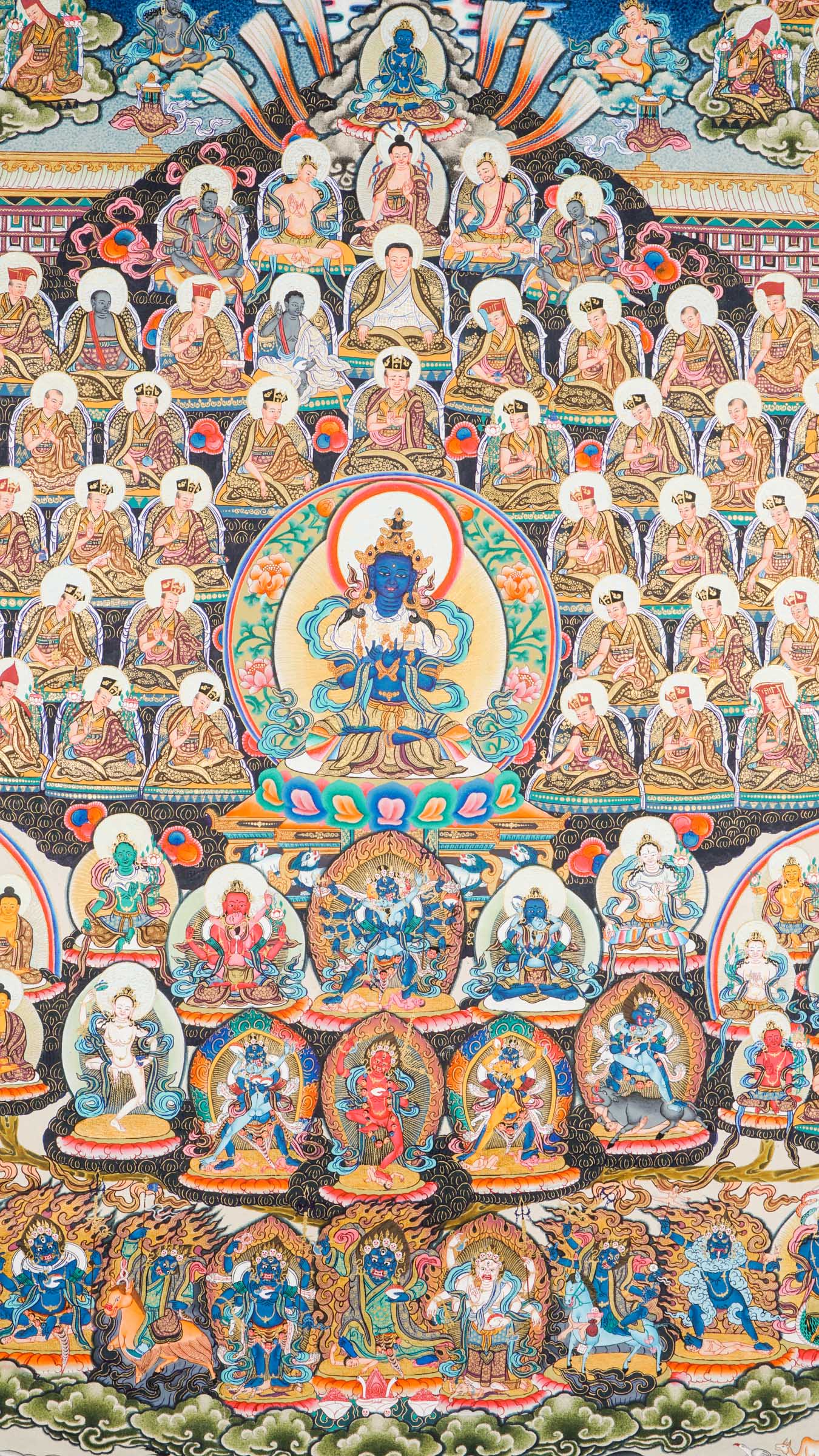 Large traditional Tibetan thangka depicting a detailed Buddhist cosmological assembly, with Vajradhara at the center surrounded by numerous Buddhas, bodhisattvas, lineage masters, and symbolic figures arranged in a complex, symmetrical composition.