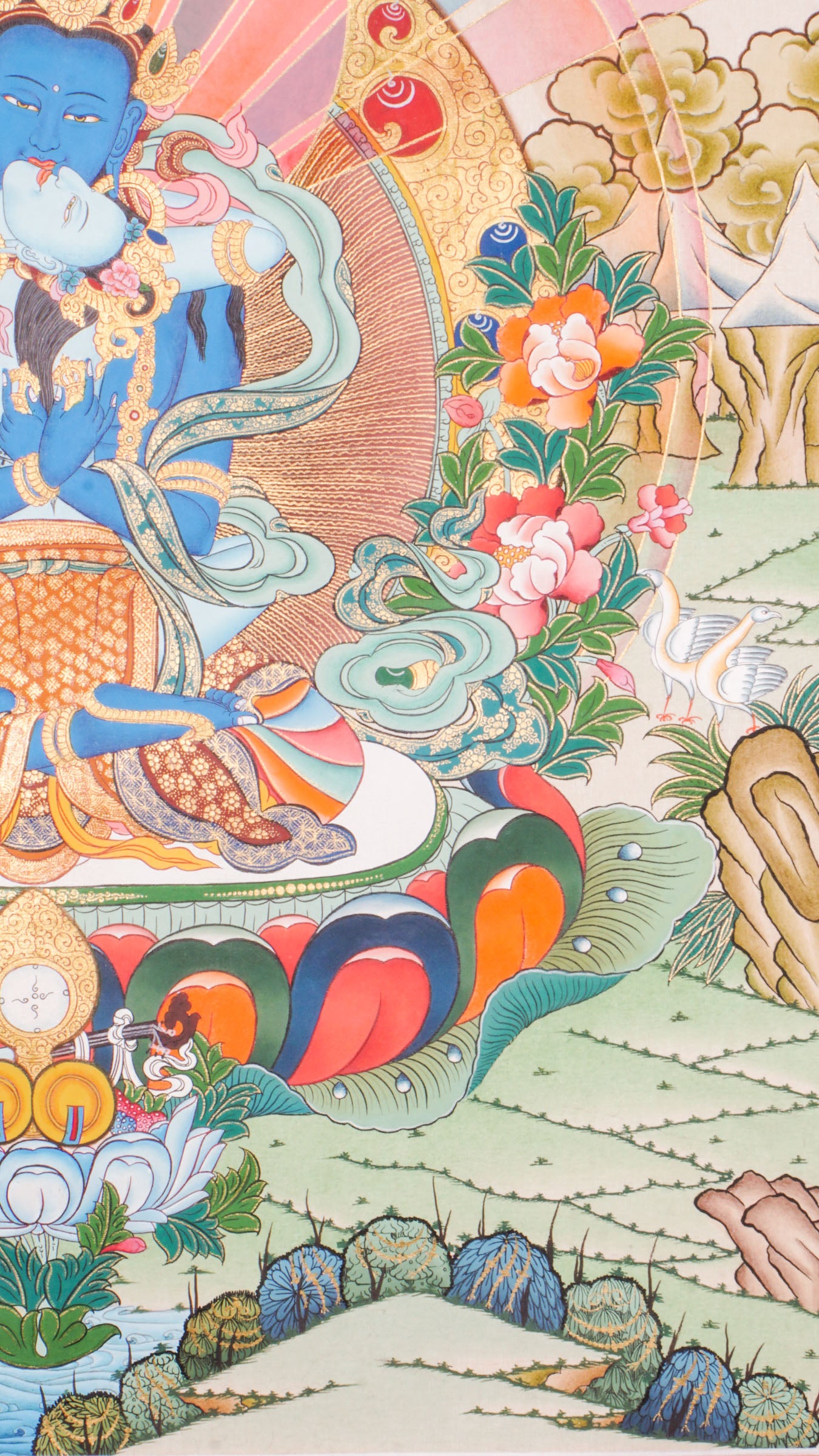 Traditional Tibetan thangka painting depicting Vajradhara Shakti in union, shown as a blue deity seated on a lotus throne with a consort, surrounded by radiant rays, clouds, floral motifs, and a symbolic landscape.