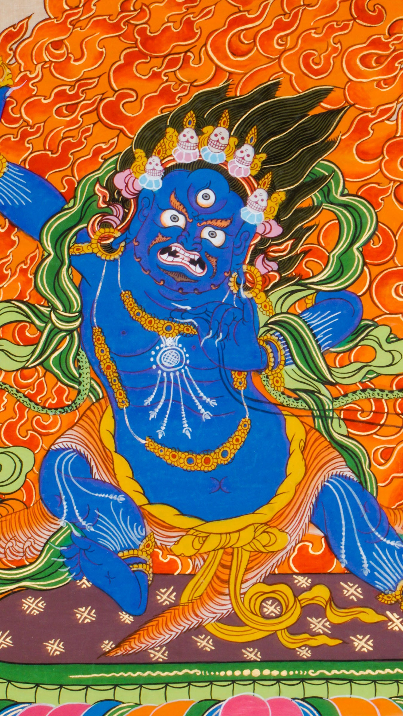 Traditional Tibetan thangka painting depicting Vajrapani, a blue-skinned wrathful deity in a powerful stance on a lotus throne, encircled by flames, with clouds and mountains in the background.