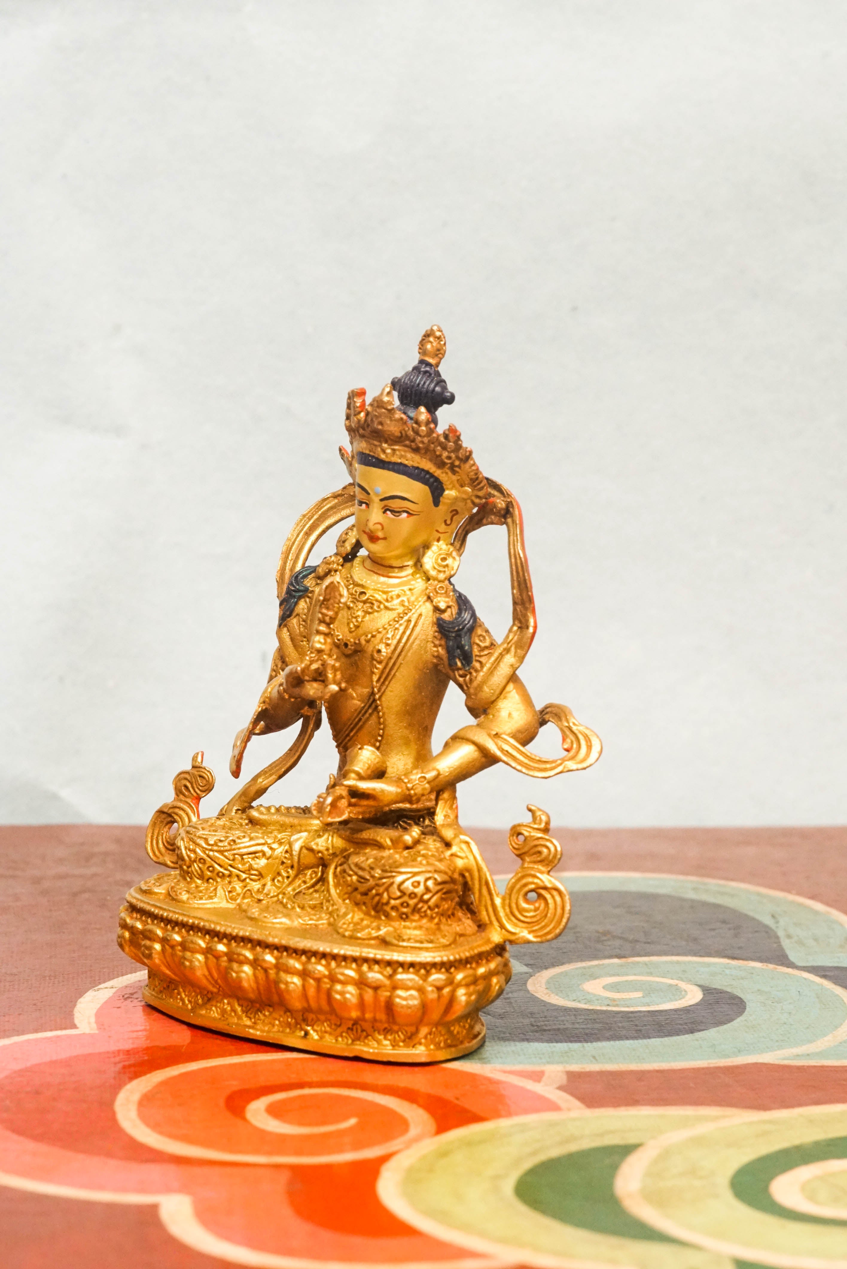 Handcrafted Vajrasattva statue seated in lotus posture, holding a vajra and bell, symbolizing spiritual purity, compassion, and wisdom in Vajrayana Buddhism.