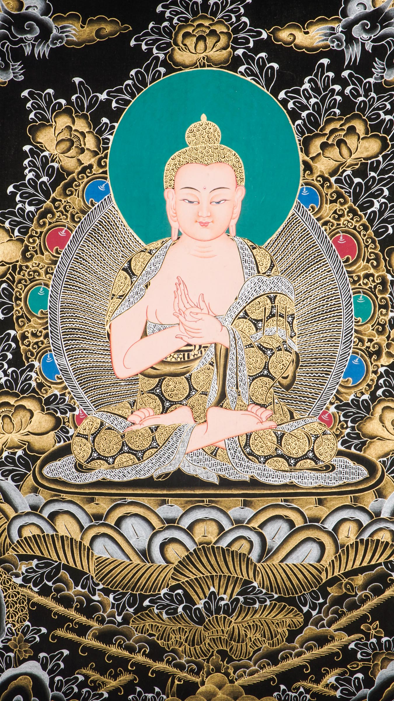 Traditional Tibetan thangka painting depicting White Buddha seated in meditation on a lotus throne, with hands in a teaching gesture, surrounded by intricate gold floral motifs on a black background and framed by sacred script.