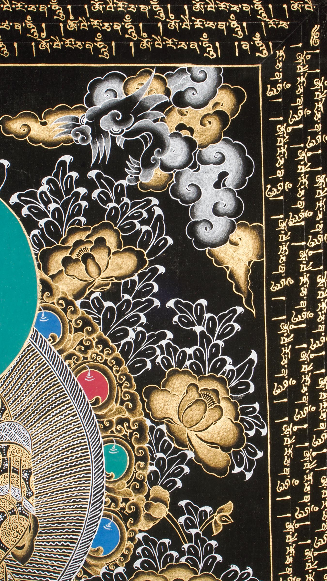 Traditional Tibetan thangka painting depicting White Buddha seated in meditation on a lotus throne, with hands in a teaching gesture, surrounded by intricate gold floral motifs on a black background and framed by sacred script.