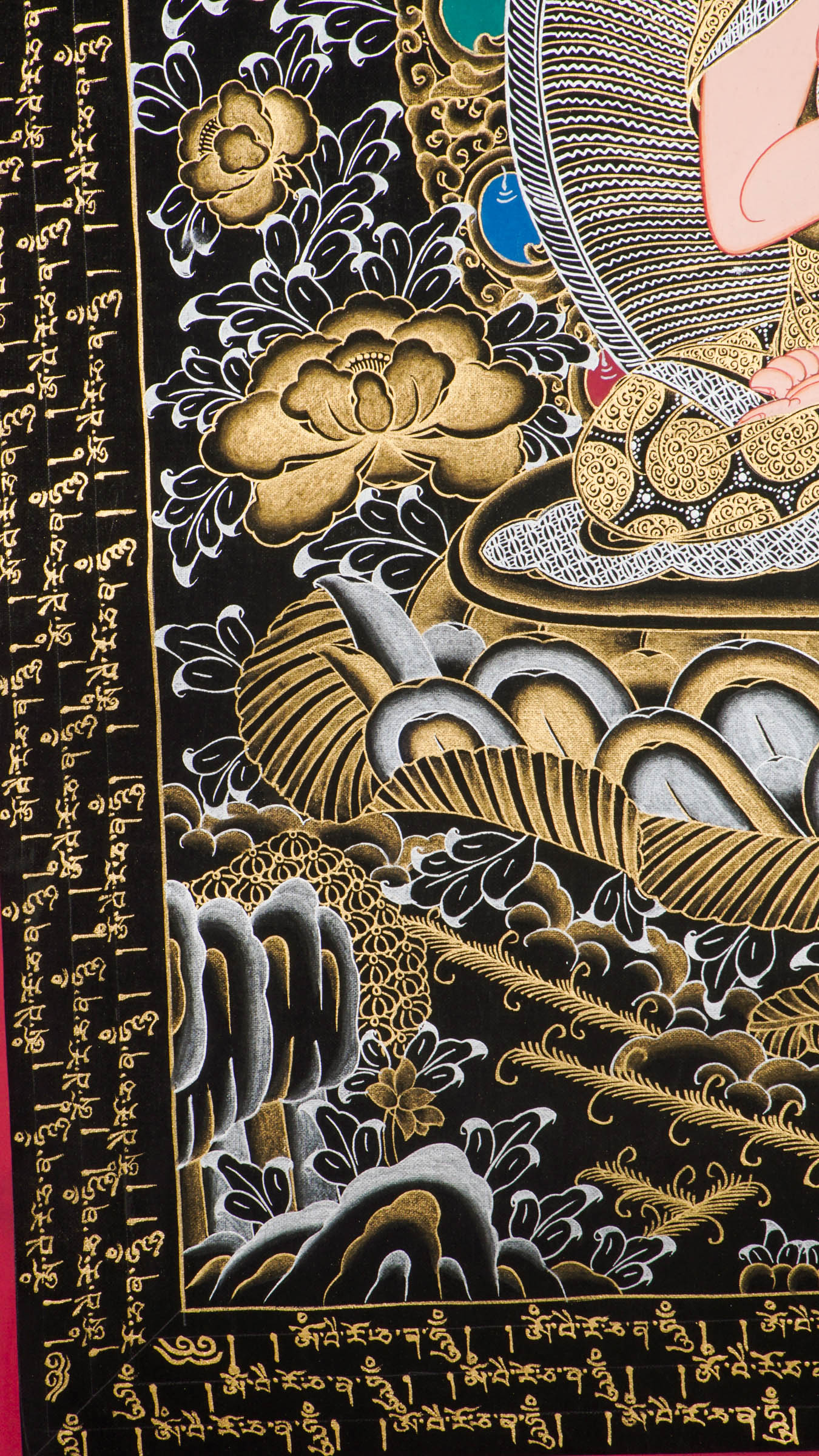 Traditional Tibetan thangka painting depicting White Buddha seated in meditation on a lotus throne, with hands in a teaching gesture, surrounded by intricate gold floral motifs on a black background and framed by sacred script.