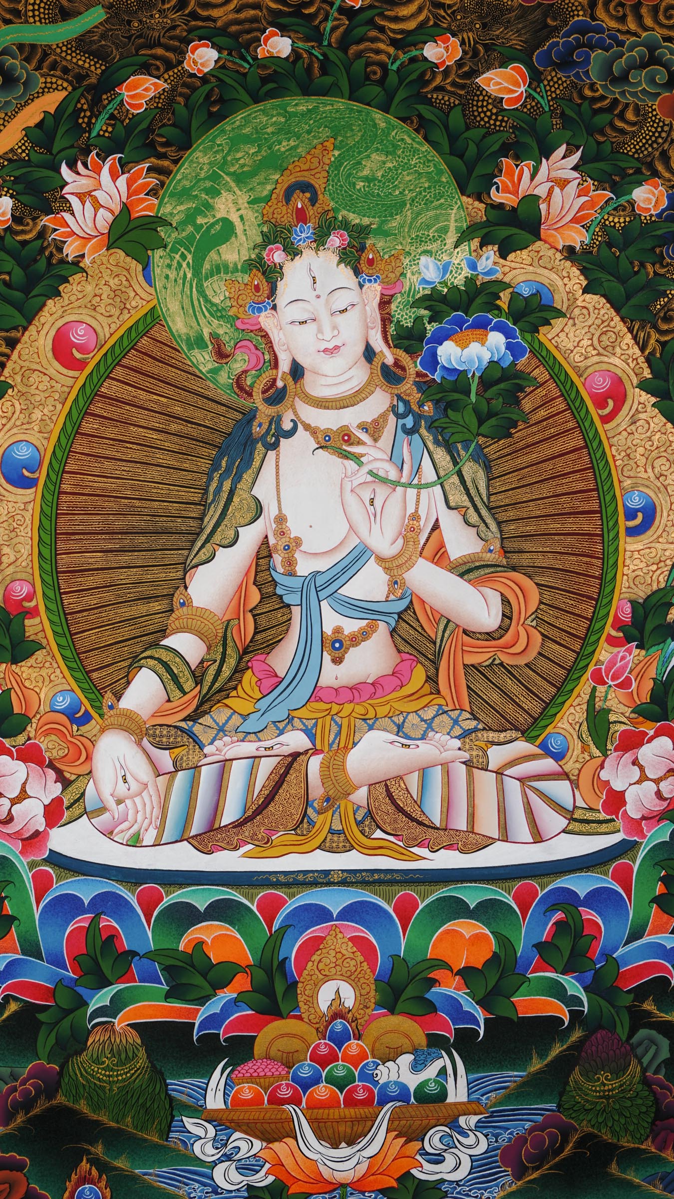 Hand-painted White Tara thangka from Kathmandu, Nepal, depicting the goddess of compassion and long life with seven eyes, seated on a lotus throne, holding a lotus stem, adorned with flowing robes, floral patterns, and gold accents.