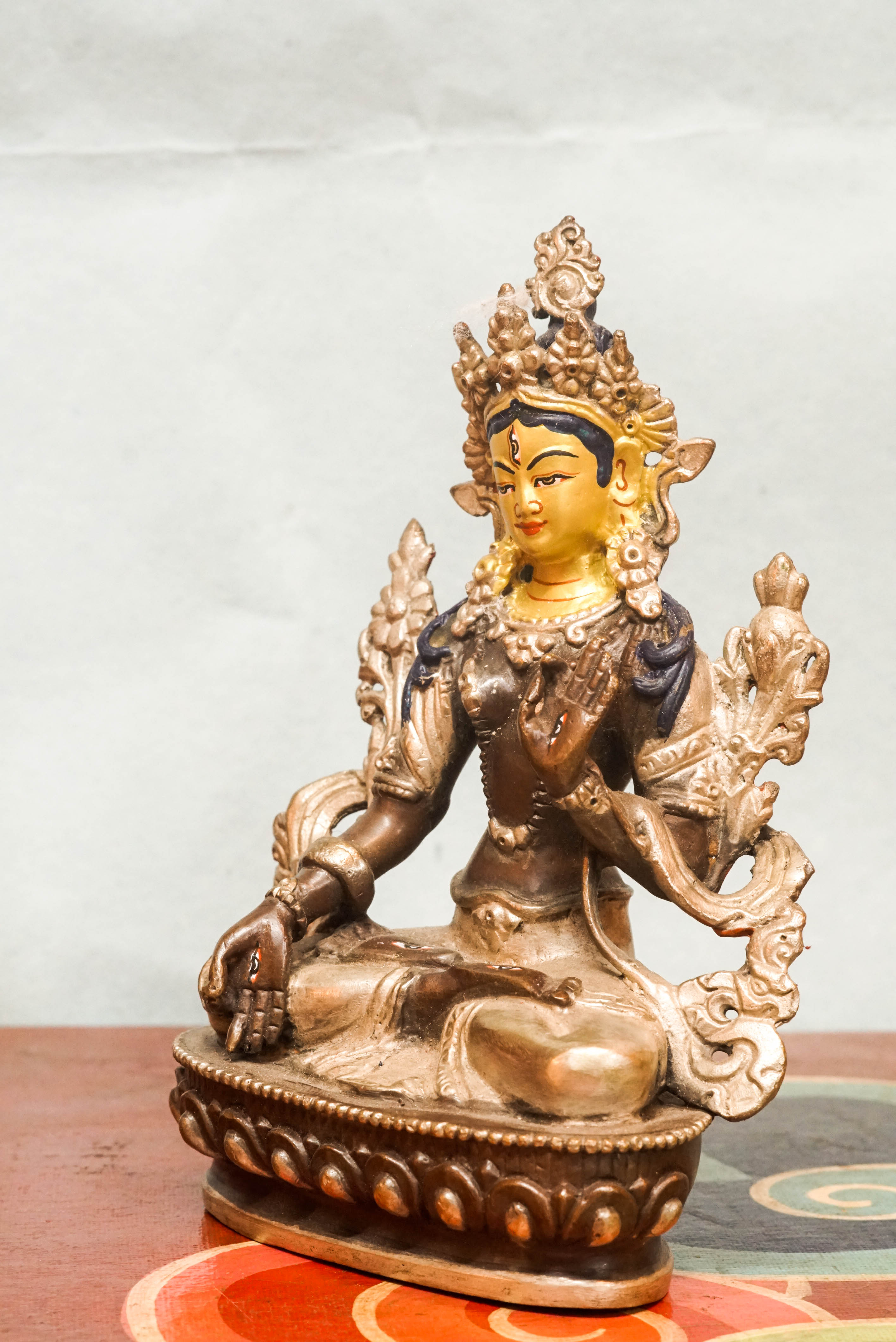 Detailed statue of White Tara, Tibetan Buddhist Bodhisattva of compassion and longevity, featuring seven eyes and traditional robes.