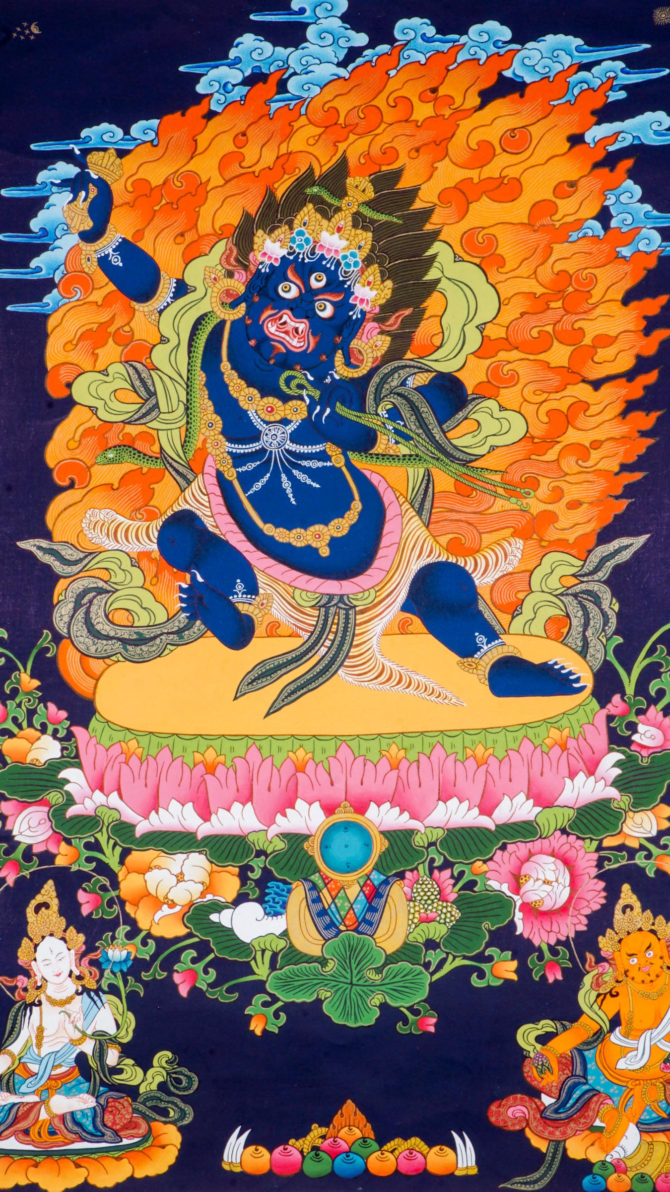 Traditional Tibetan thangka painting depicting wrathful Vajrapani, a blue-skinned deity in a powerful dynamic pose on a lotus throne, surrounded by blazing flames, clouds, and ornate symbolic details against a deep blue background.