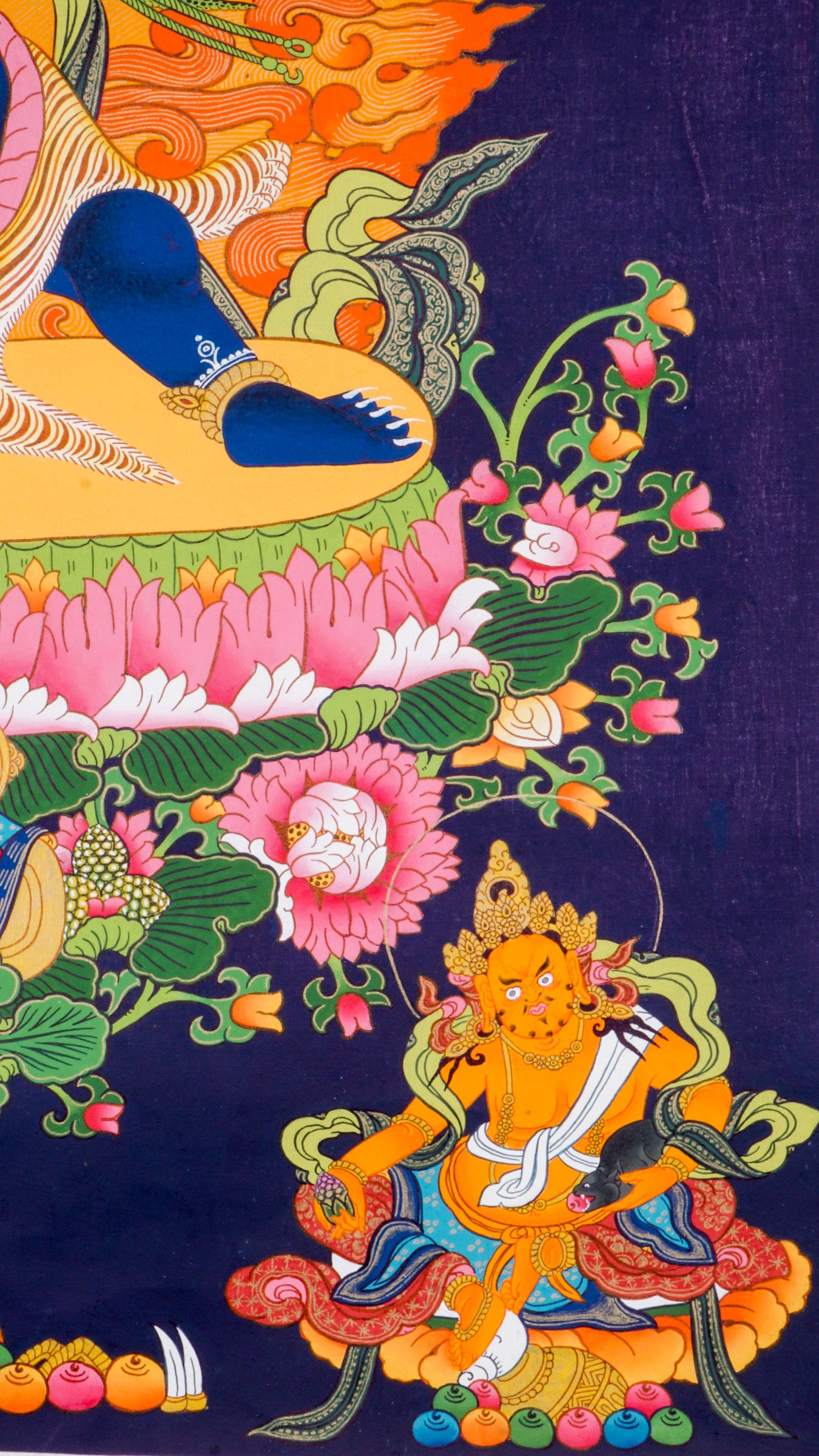 Traditional Tibetan thangka painting depicting wrathful Vajrapani, a blue-skinned deity in a powerful dynamic pose on a lotus throne, surrounded by blazing flames, clouds, and ornate symbolic details against a deep blue background.
