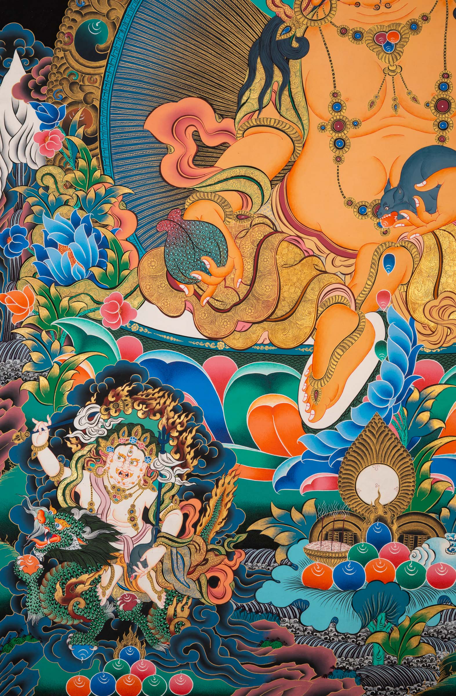 Zambala thangka painting showing a golden seated figure with wide eyes and ornate jewelry, positioned on a lotus base, surrounded by floral patterns, clouds, and multiple smaller seated figures above and below against a dark background.