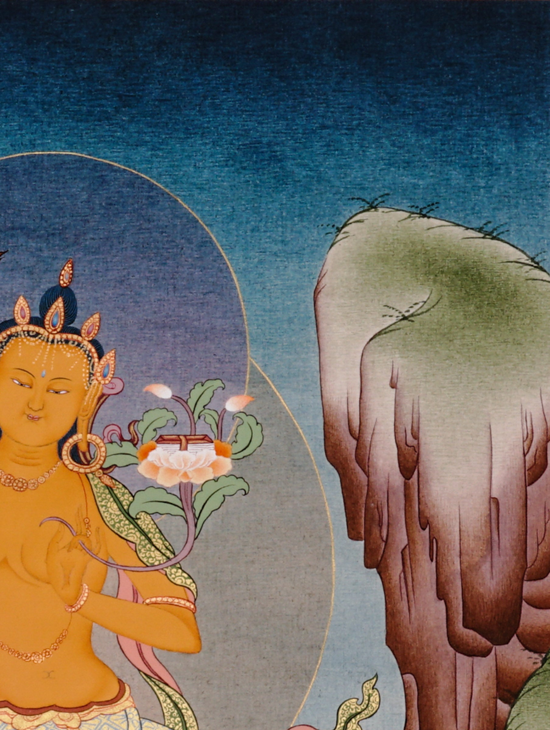 Manjushree Bodhisattva seated on a pink lotus above flowing water, holding flaming wisdom sword and sacred scripture lotus.