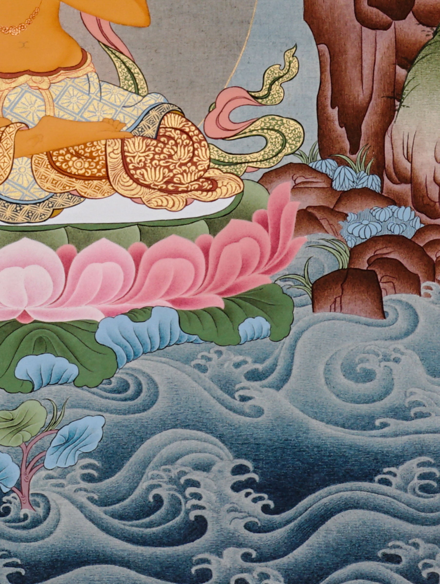 Manjushree Bodhisattva seated on a pink lotus above flowing water, holding flaming wisdom sword and sacred scripture lotus.