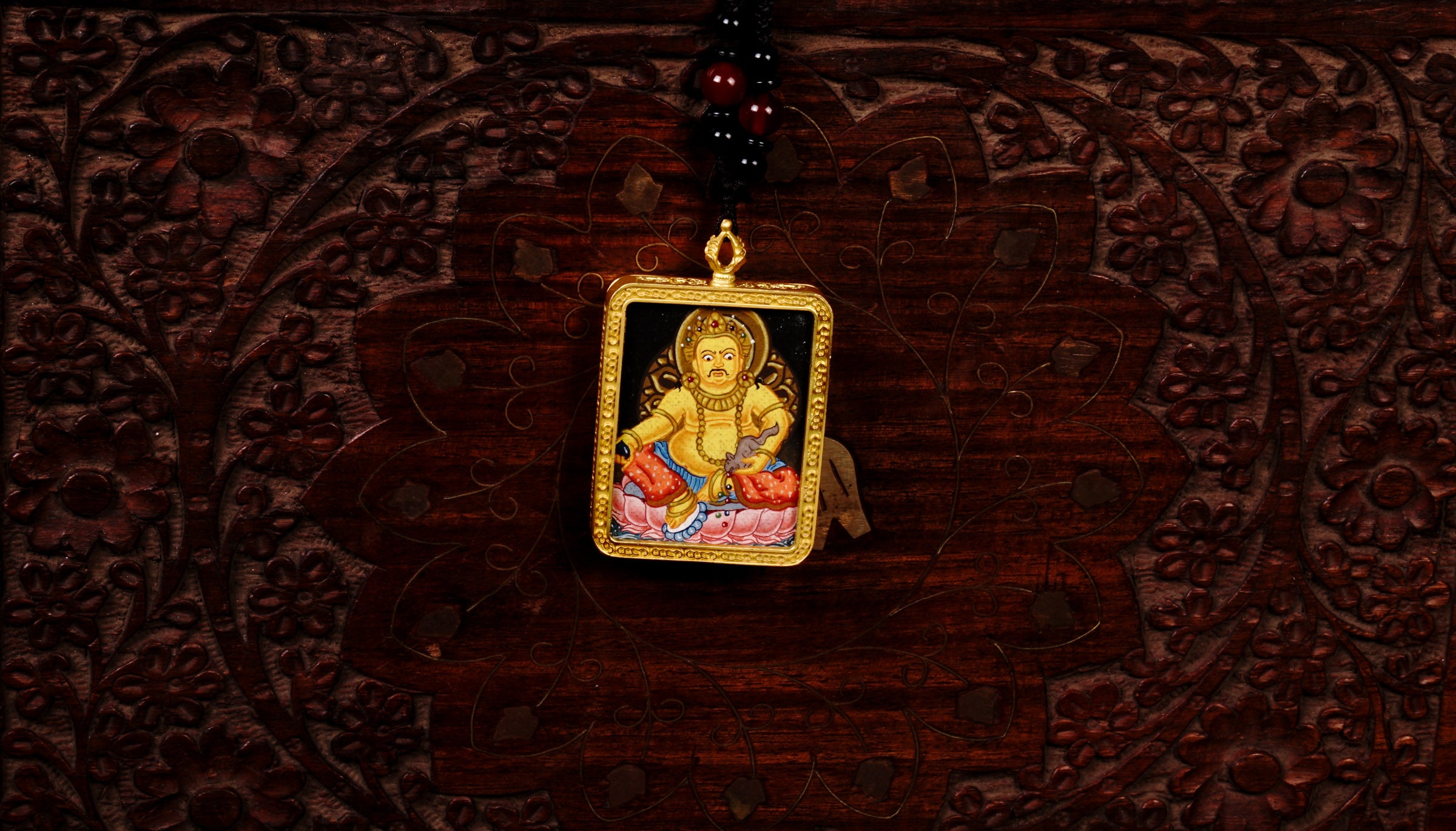 Hand-painted Yellow Zambala miniature Thangka pendant in gold-accented copper Ghau locket with black beaded cord.