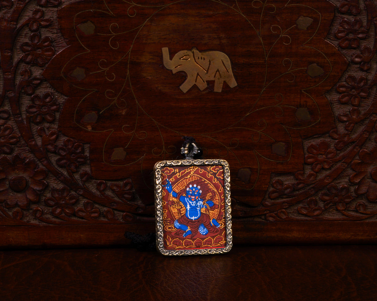Khadgapani (Black Manjushree) Ghau pendant featuring a miniature Tibetan Buddhist wisdom protector artwork in a traditional metal frame handcrafted in Nepal.