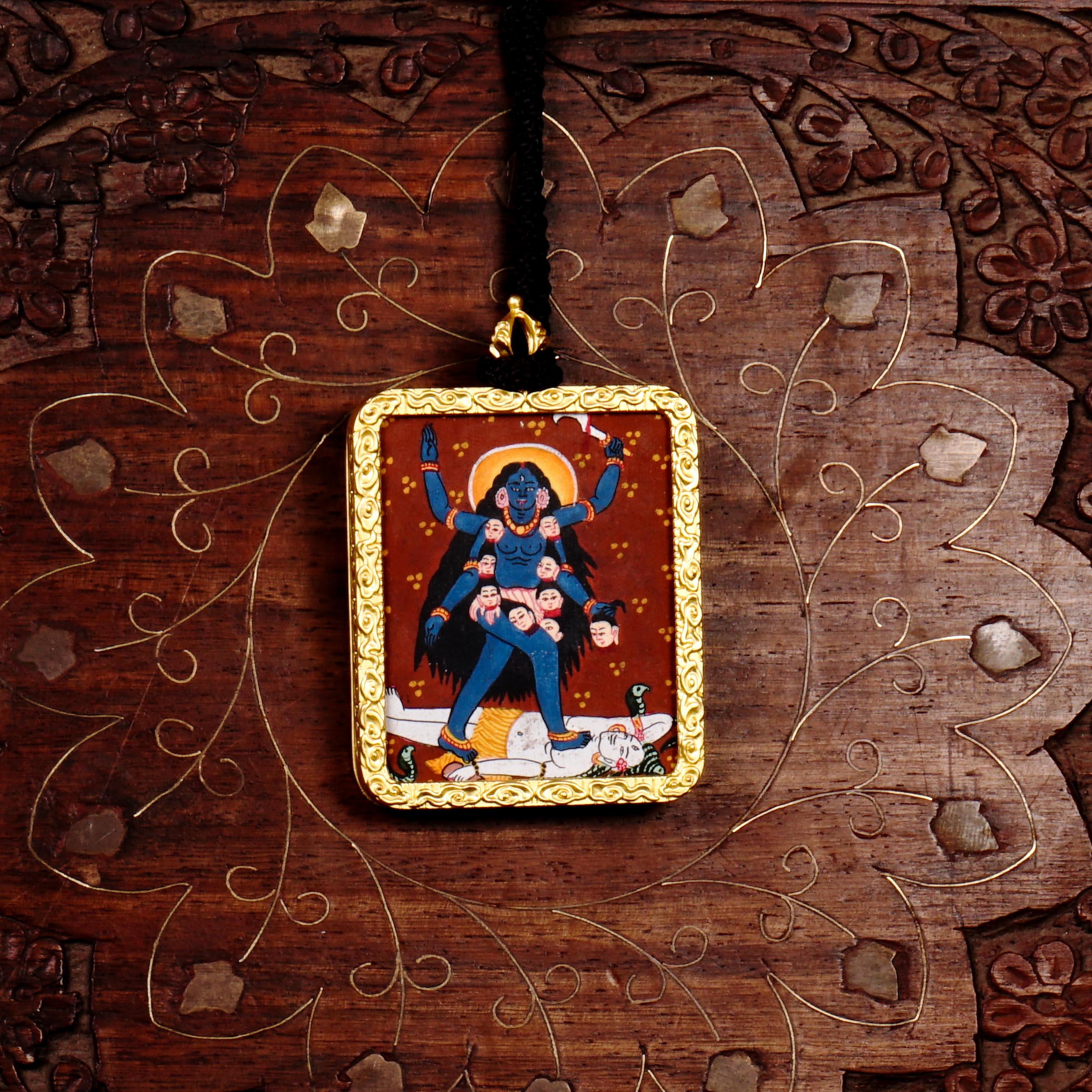 Hand-painted Goddess Kali miniature Thangka pendant in gold-accented copper Ghau locket with black beaded cord.