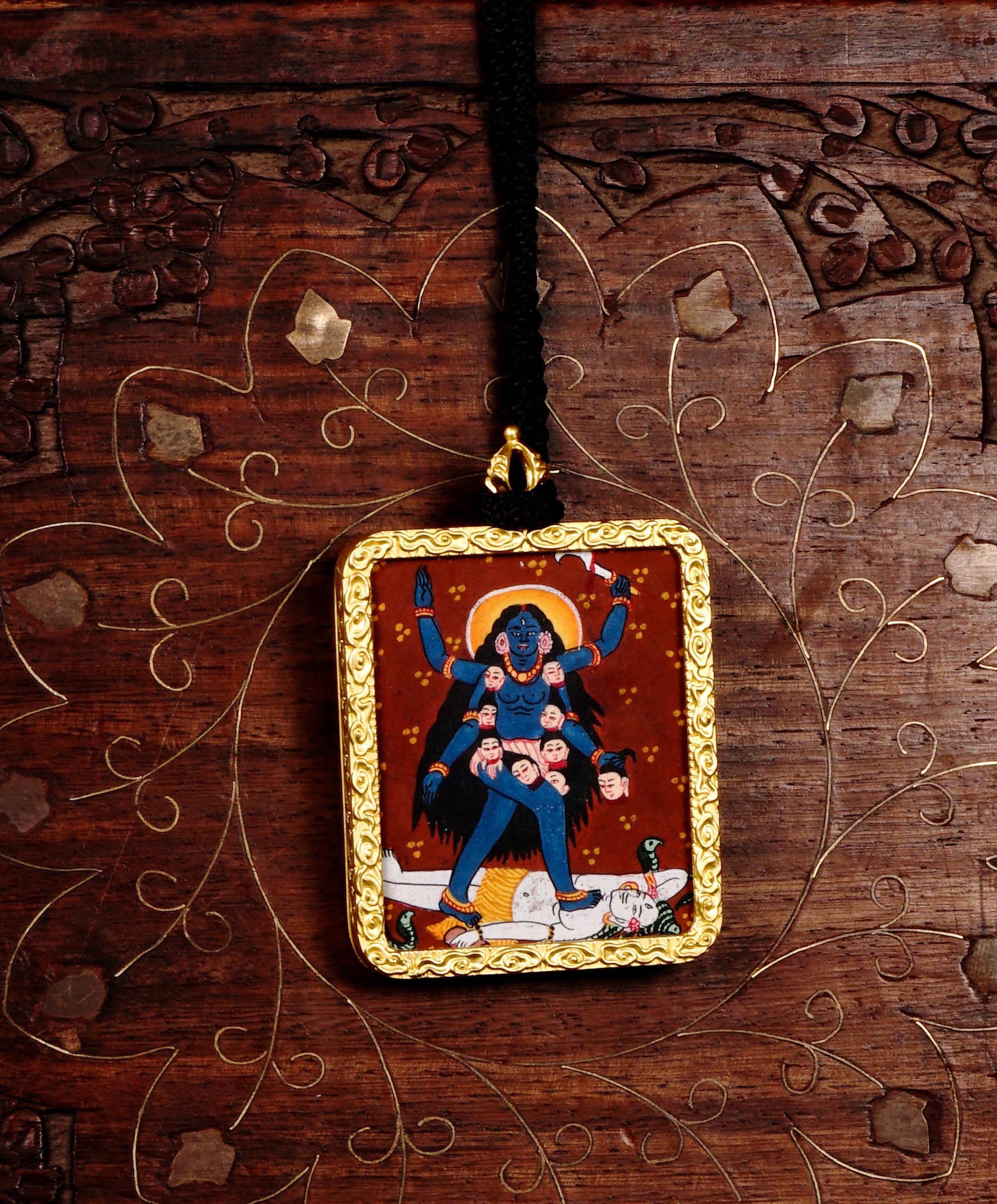 Hand-painted Goddess Kali miniature Thangka pendant in gold-accented copper Ghau locket with black beaded cord.