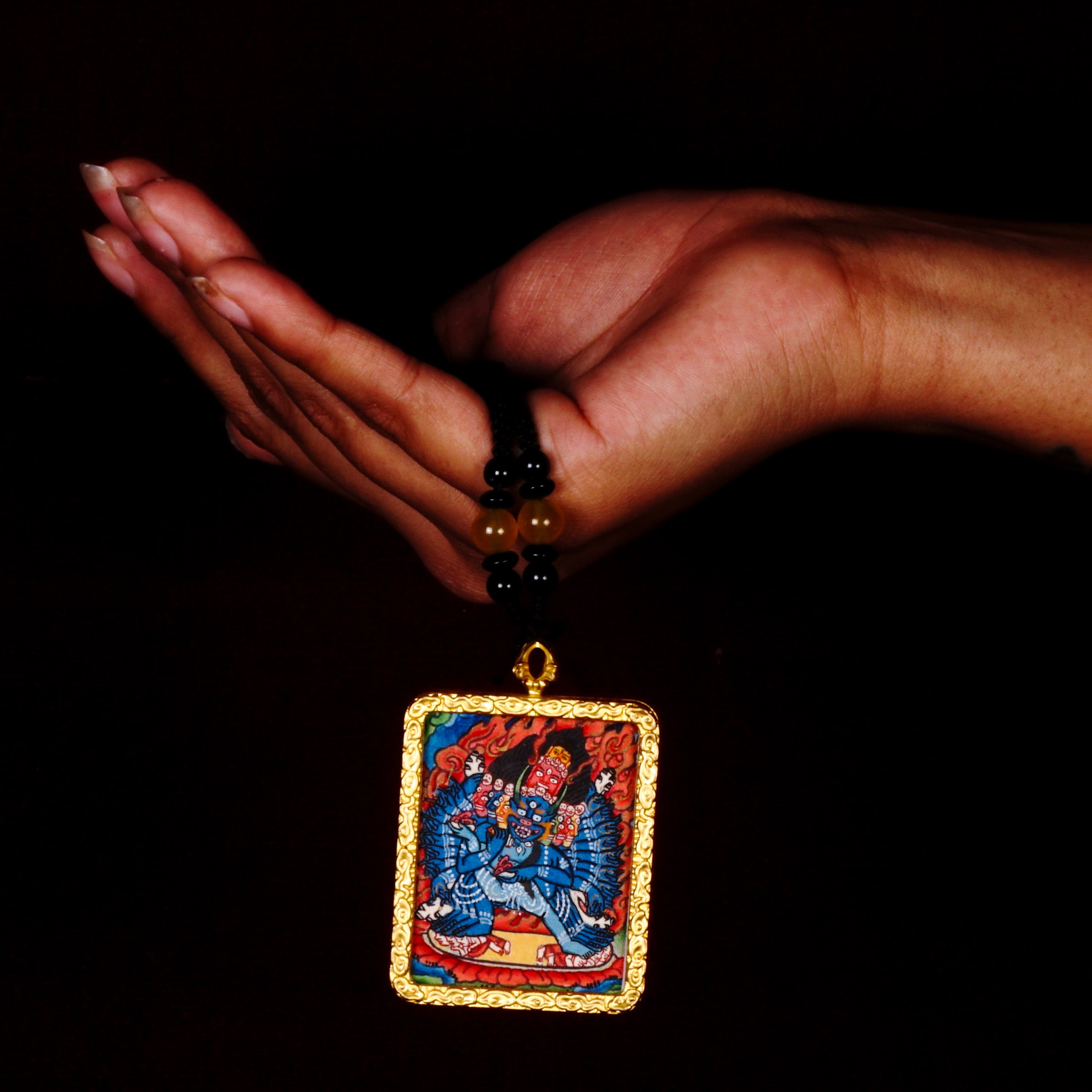 Hand-painted Yamantaka miniature Thangka pendant in gold-accented copper Ghau locket with black beaded cord.