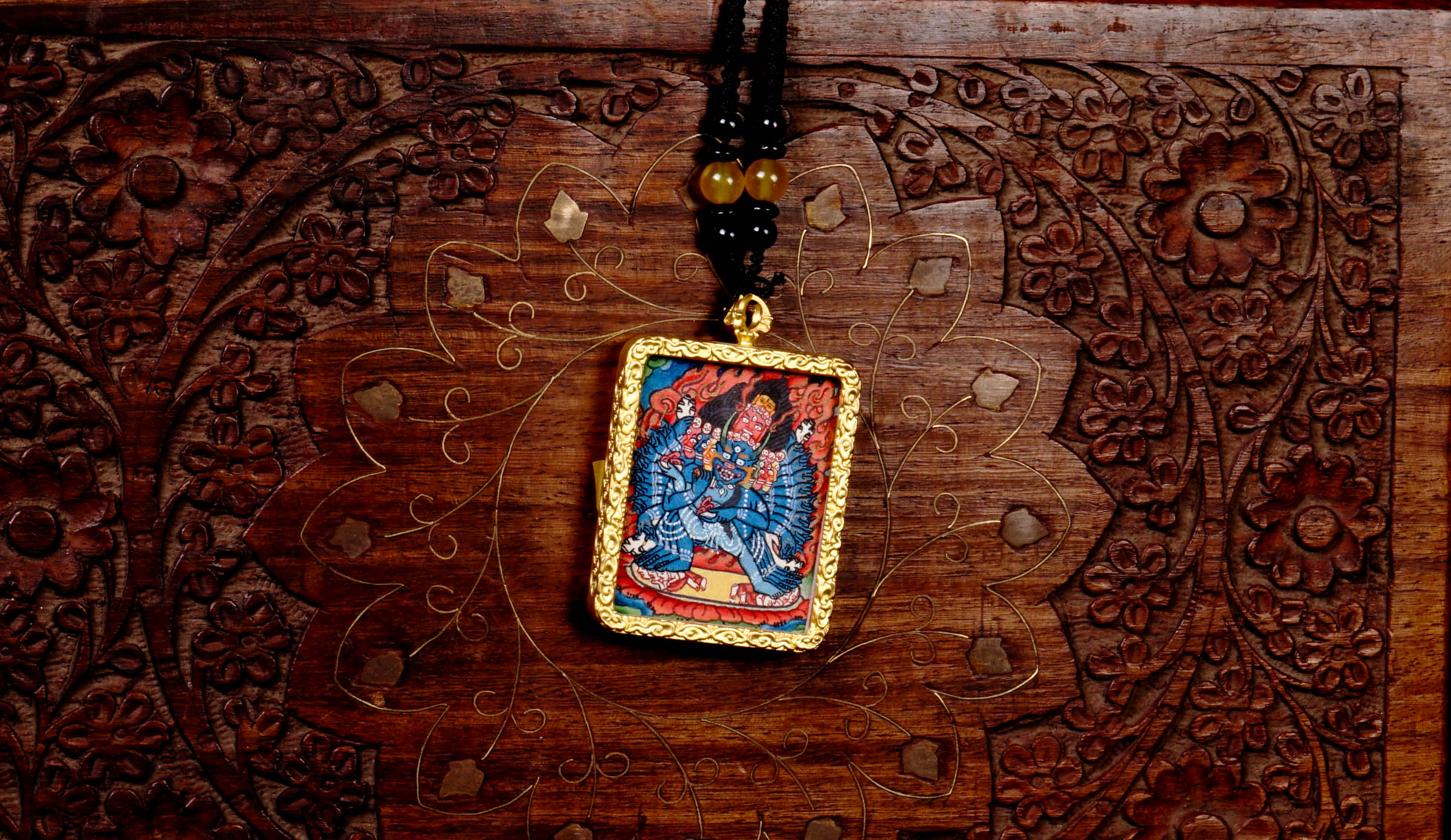 Hand-painted Yamantaka miniature Thangka pendant in gold-accented copper Ghau locket with black beaded cord.