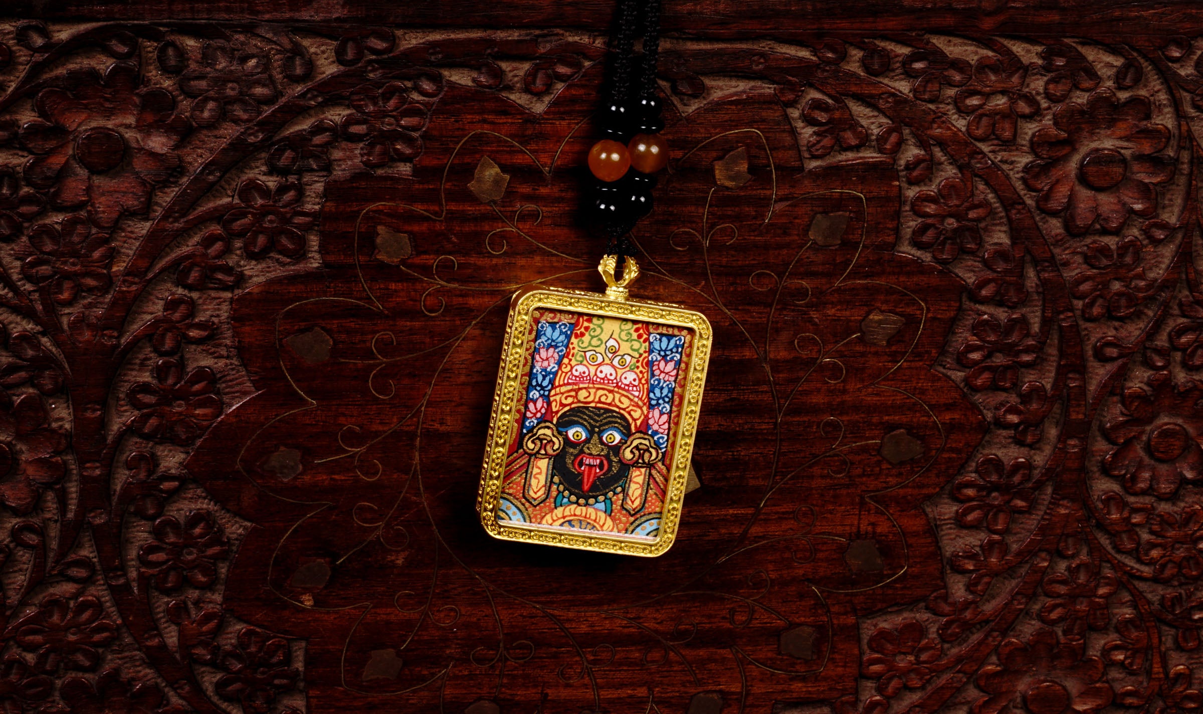 Hand-painted Goddess Kali miniature Thangka pendant in gold-accented copper Ghau locket with black beaded cord.