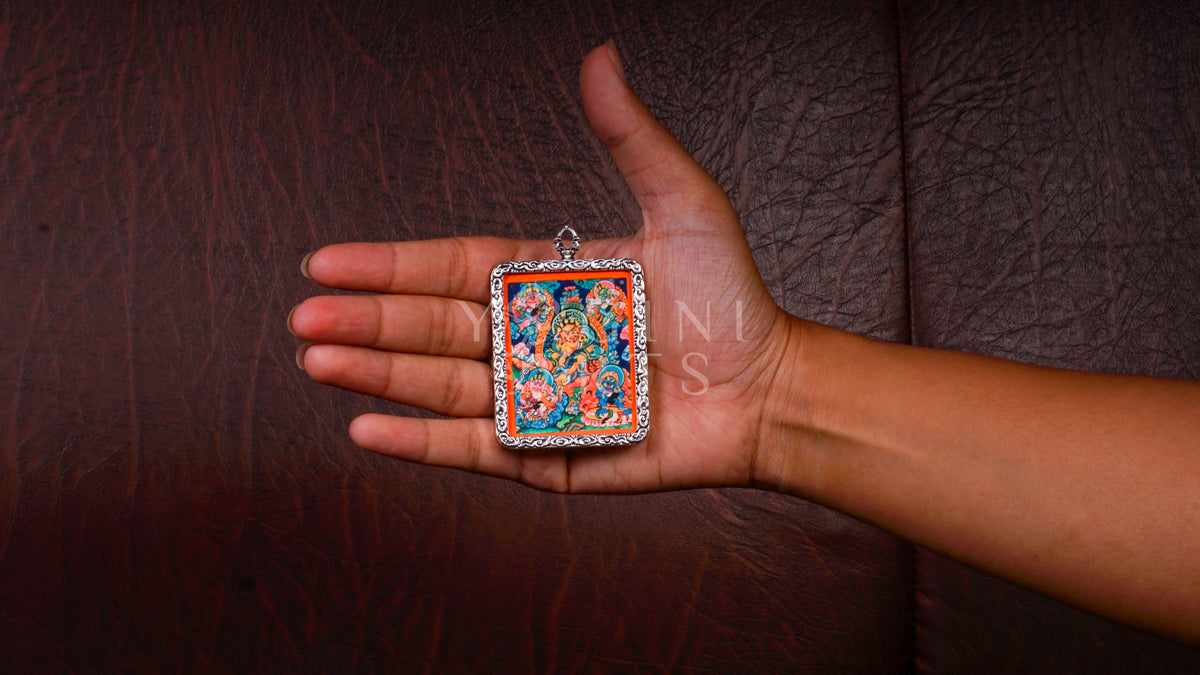 Hand-painted Five Zambhala Ghau pendant featuring the Five Buddhist Wealth Deities in a handcrafted silver-tone frame made in Nepal.